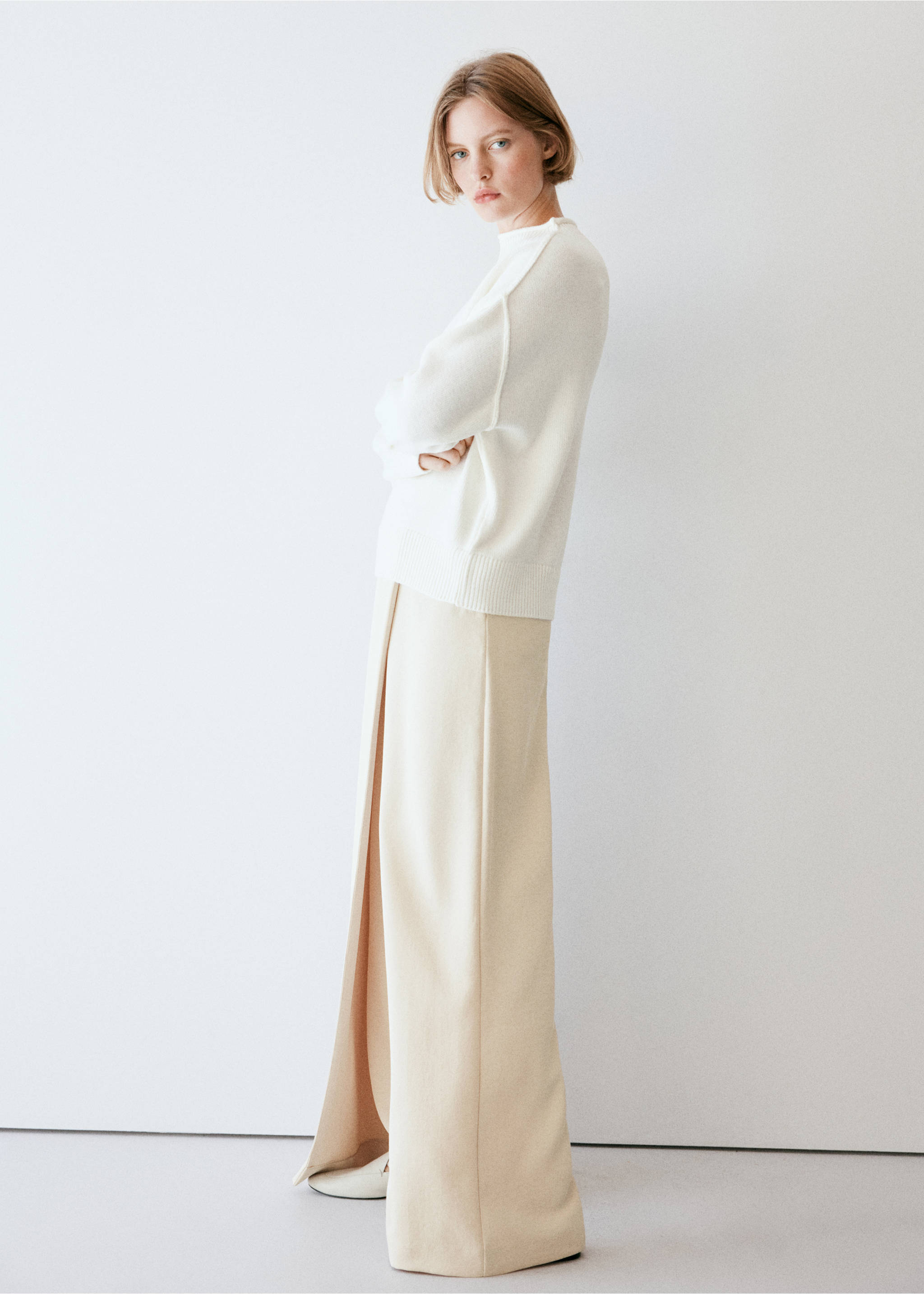 Pale beige wide-leg trousers with a front overlay, worn with a white sweater., Ecru. Ref: 37064084-01.