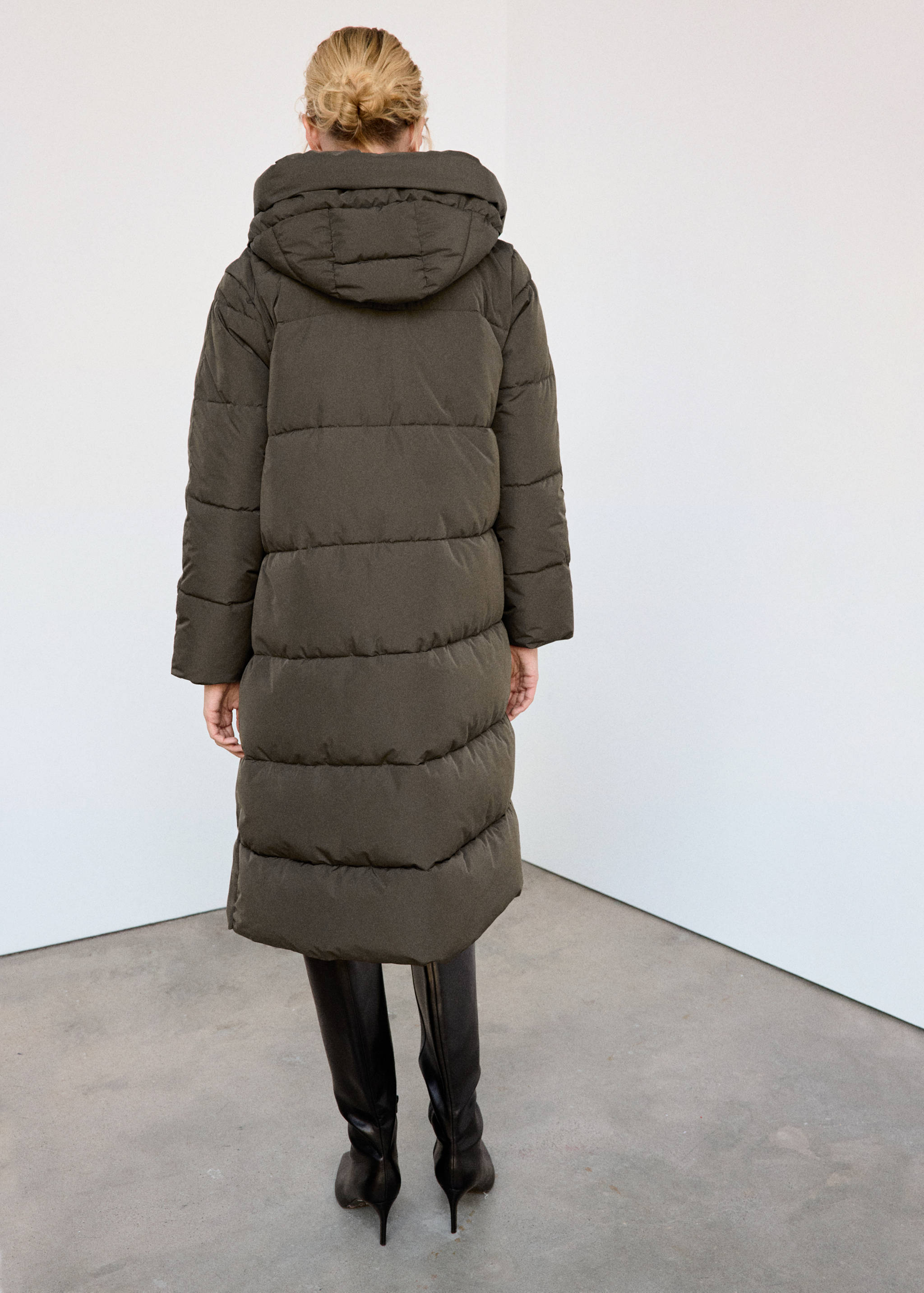 Dark olive green quilted anorak in a long, hooded design, shown from the back.