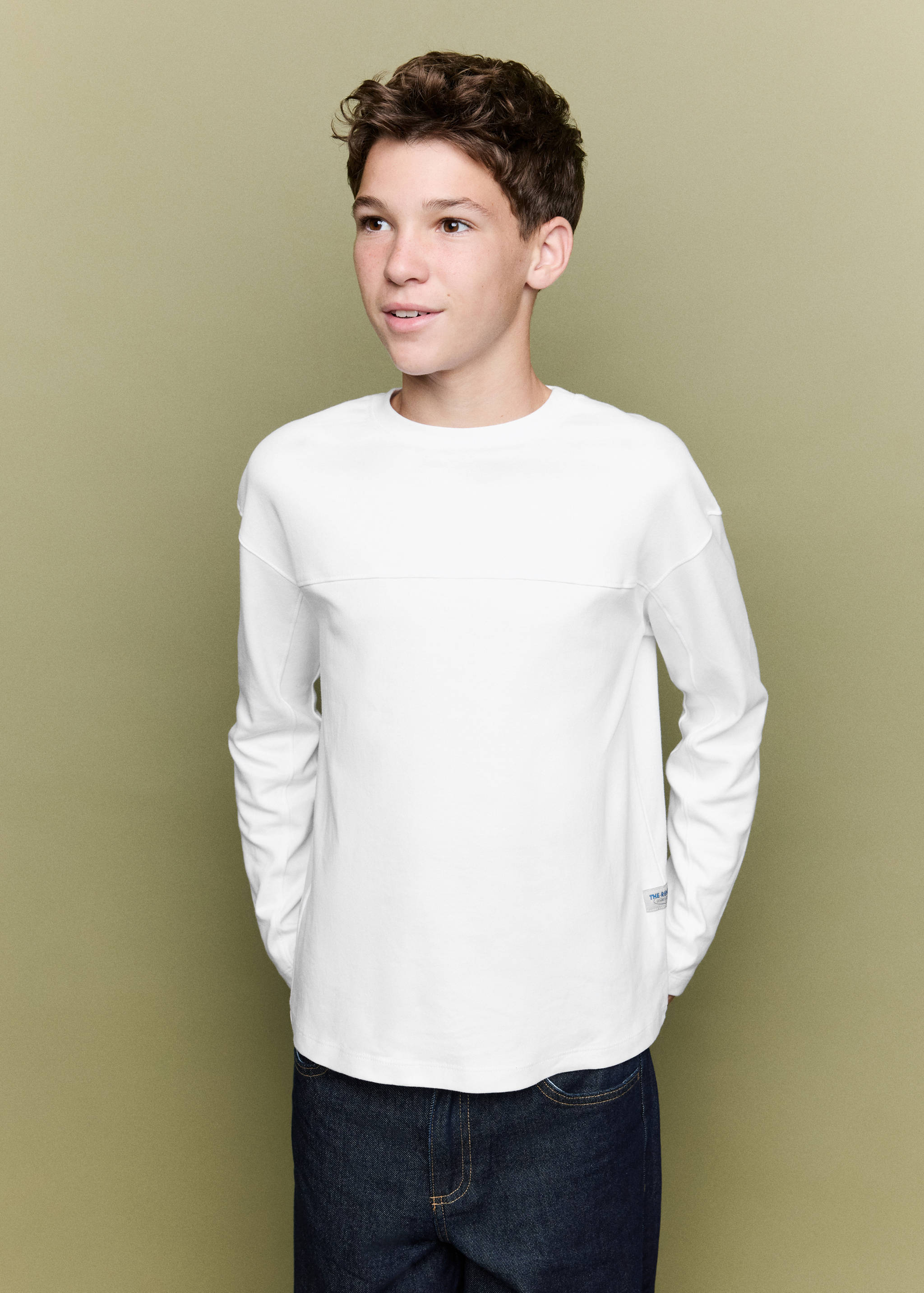 White long-sleeved crew-neck t-shirt with dropped shoulders.
