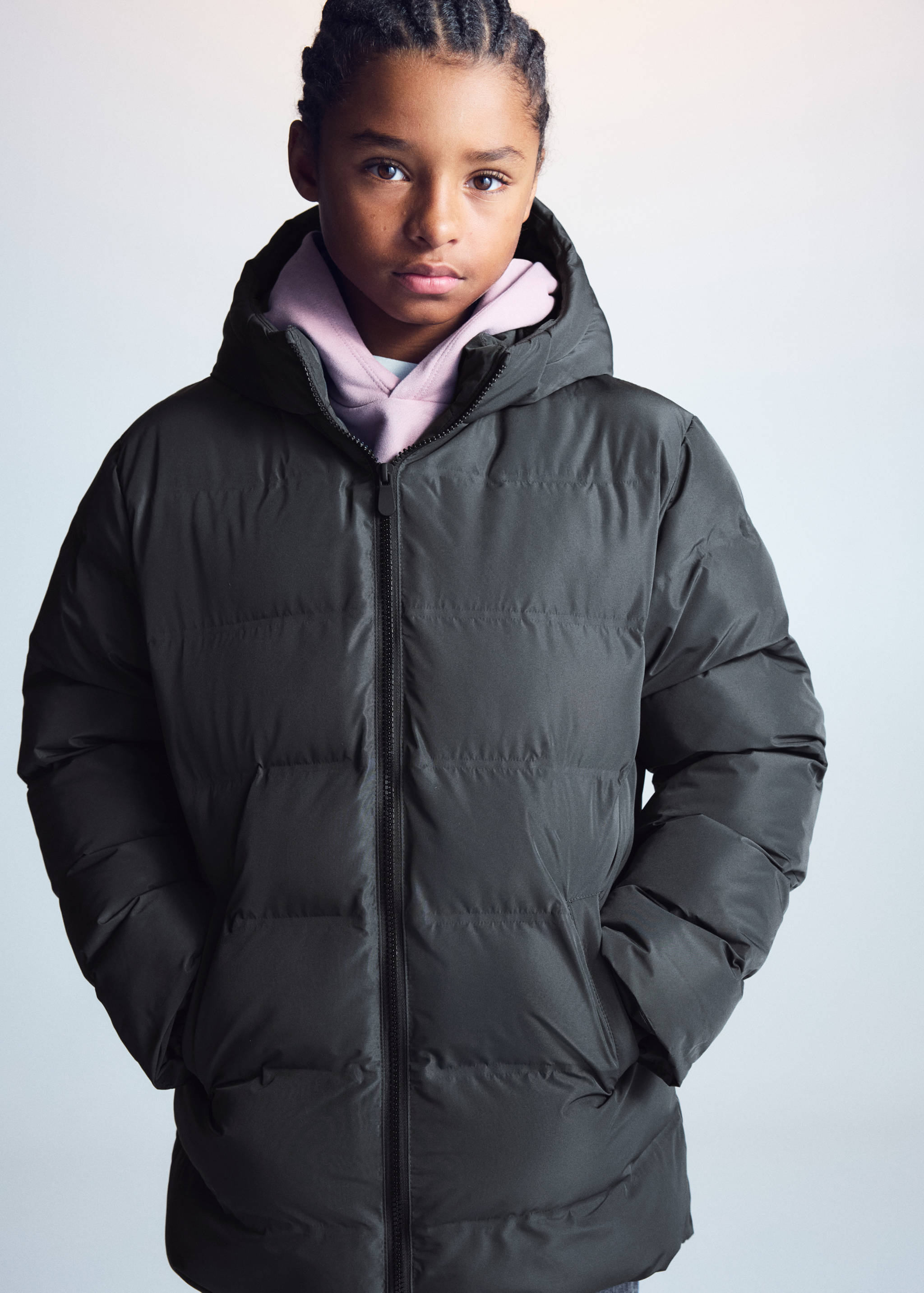 Dark green hooded anorak worn over a light pink hooded sweatshirt.