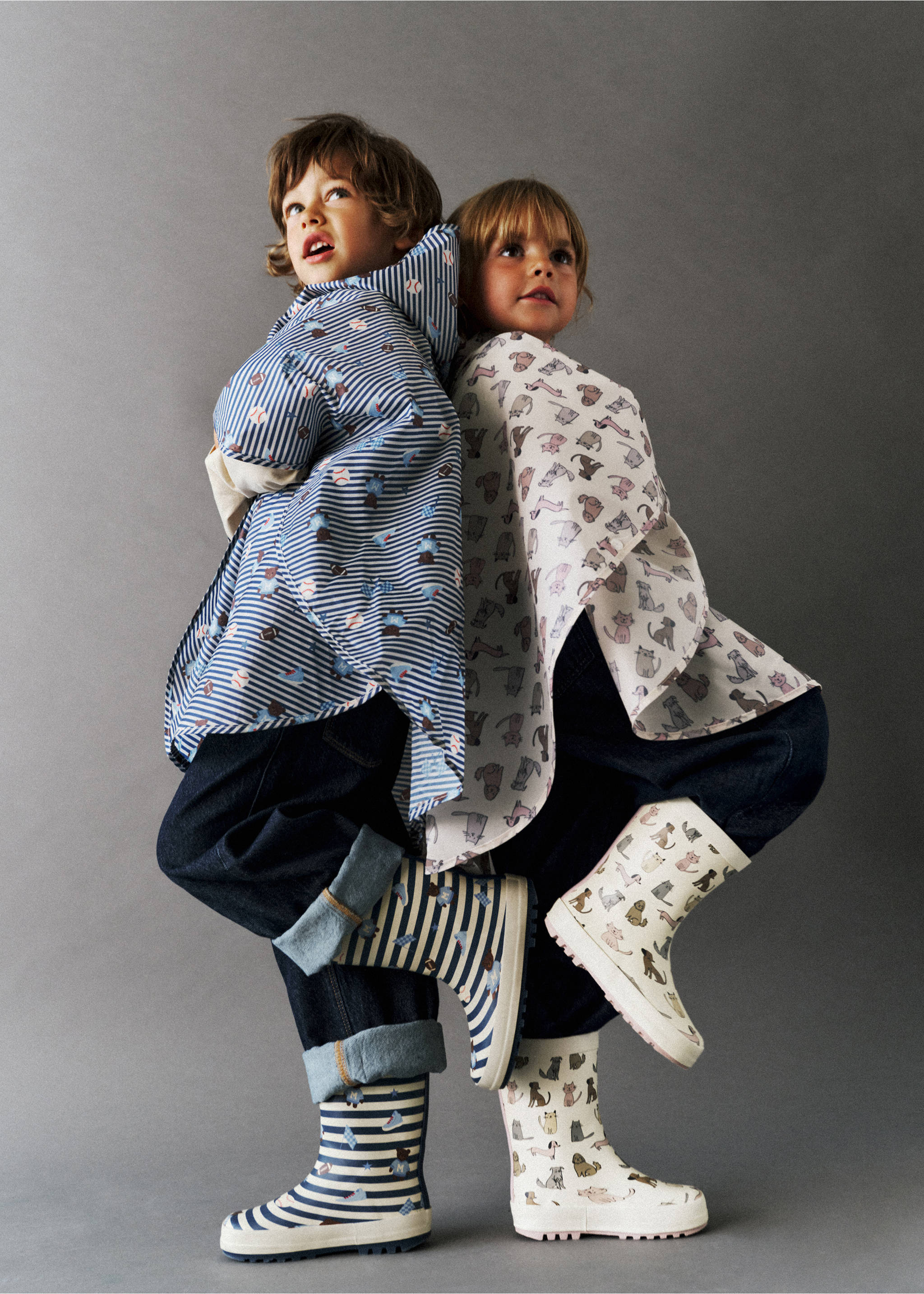 Kids' patterned rain boots worn by two children posing back-to-back., Sky Blue. Ref: 37064777-00.