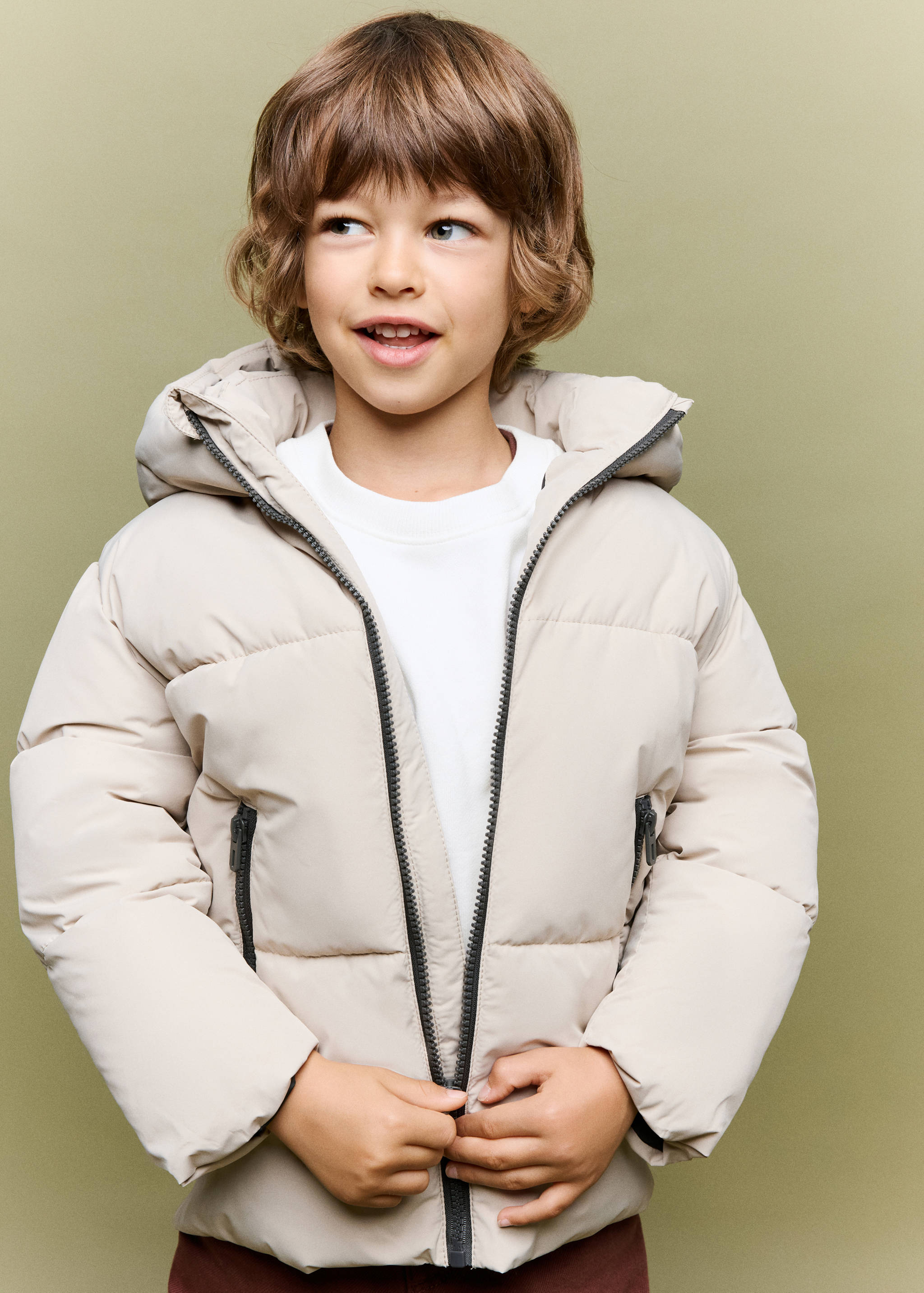 Beige quilted anorak with a hood and zipped pockets.
