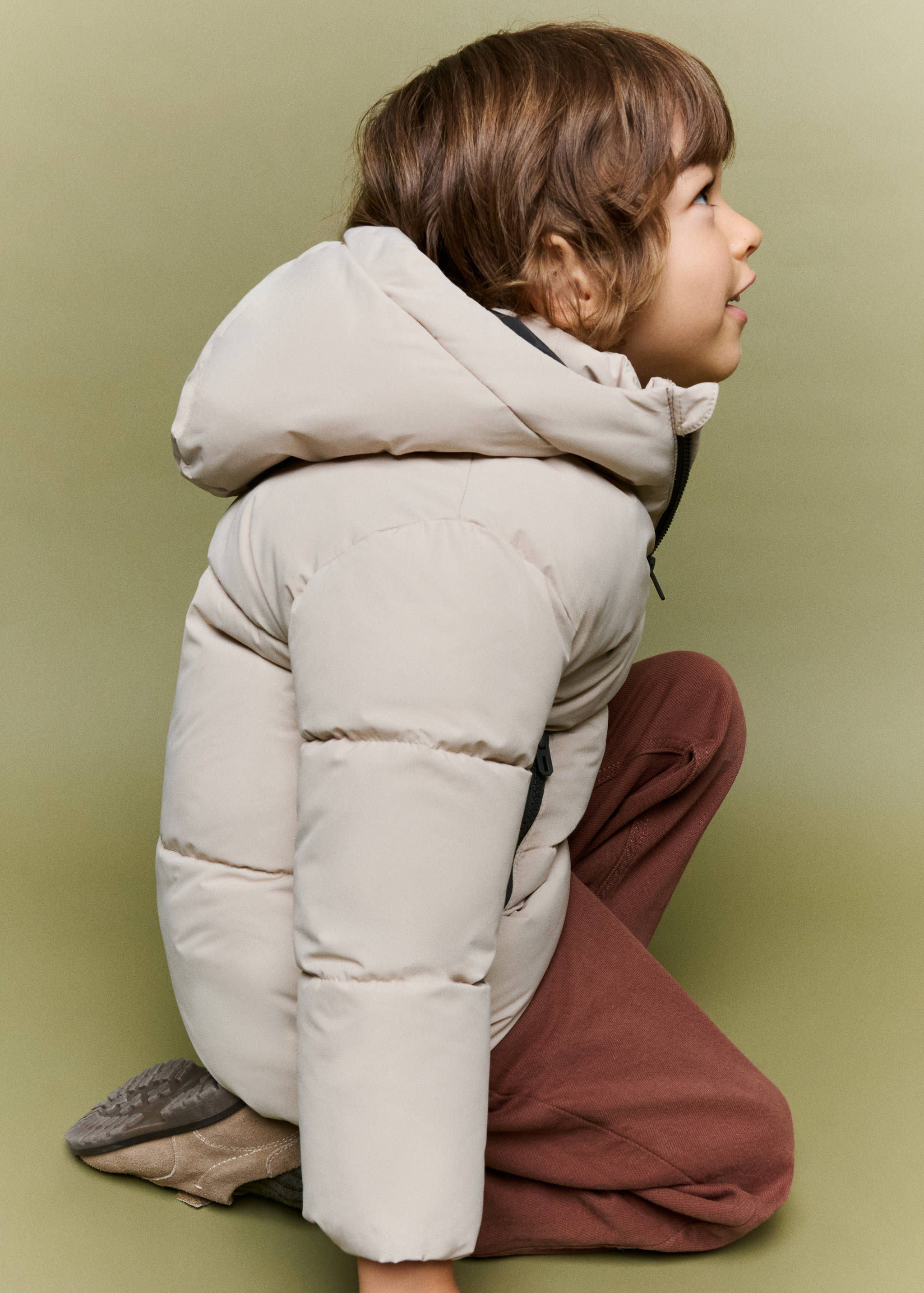 Light beige quilted anorak with a hood.