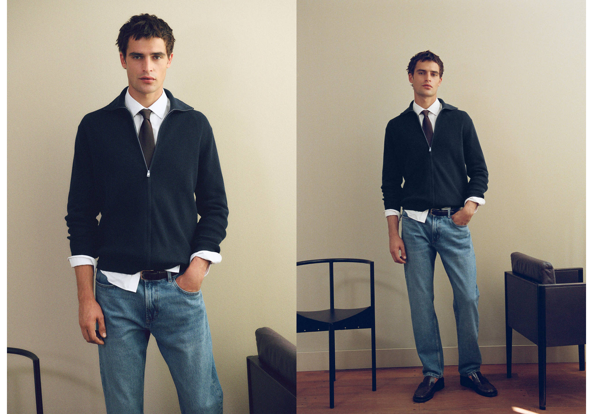 Navy blue zip-up cardigan worn with a white shirt, tie, and light blue jeans.