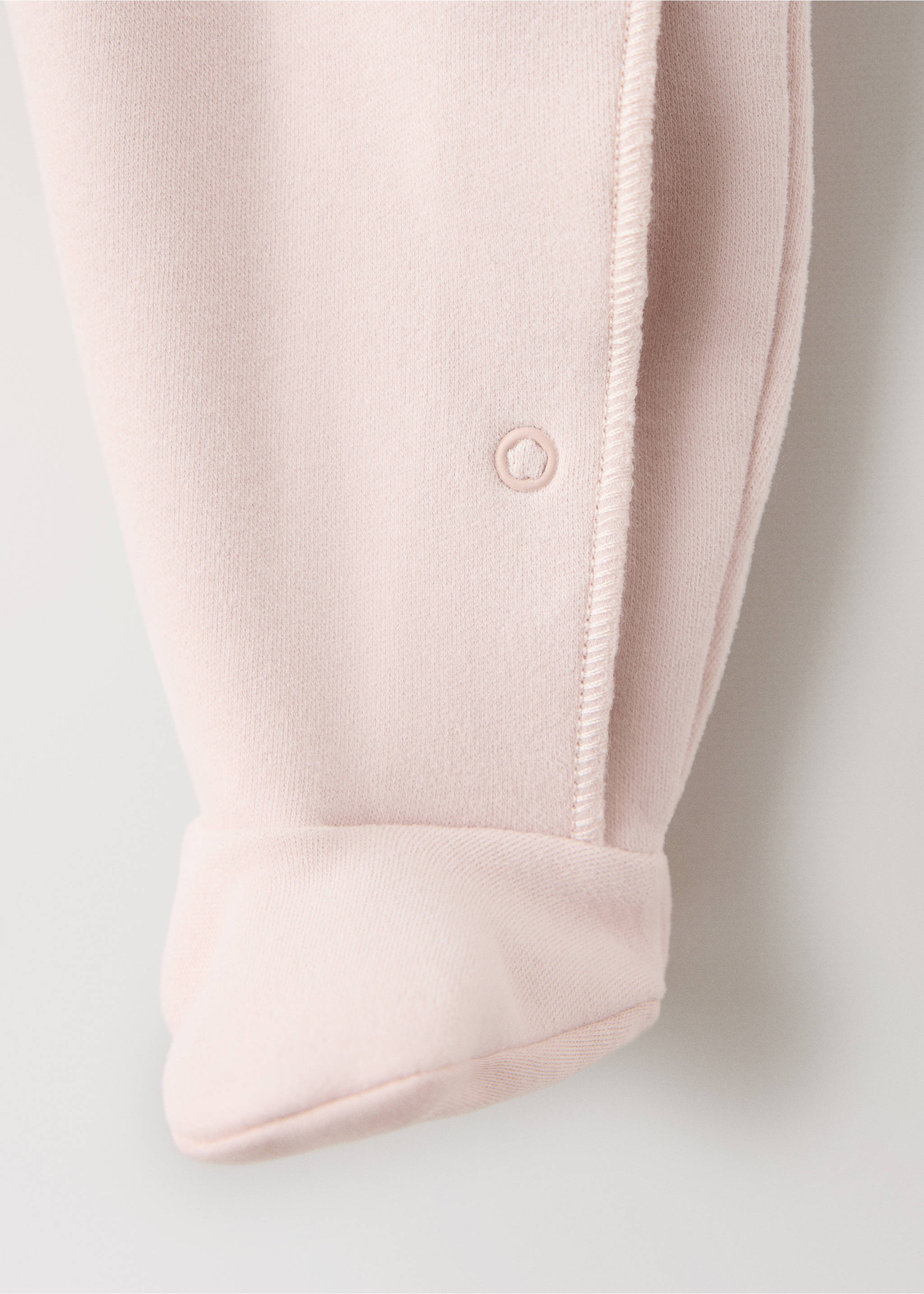 Close-up of a pale pink pyjama jumpsuit showing the leg detail and press stud closure., Nude. Ref: 37065179-00.