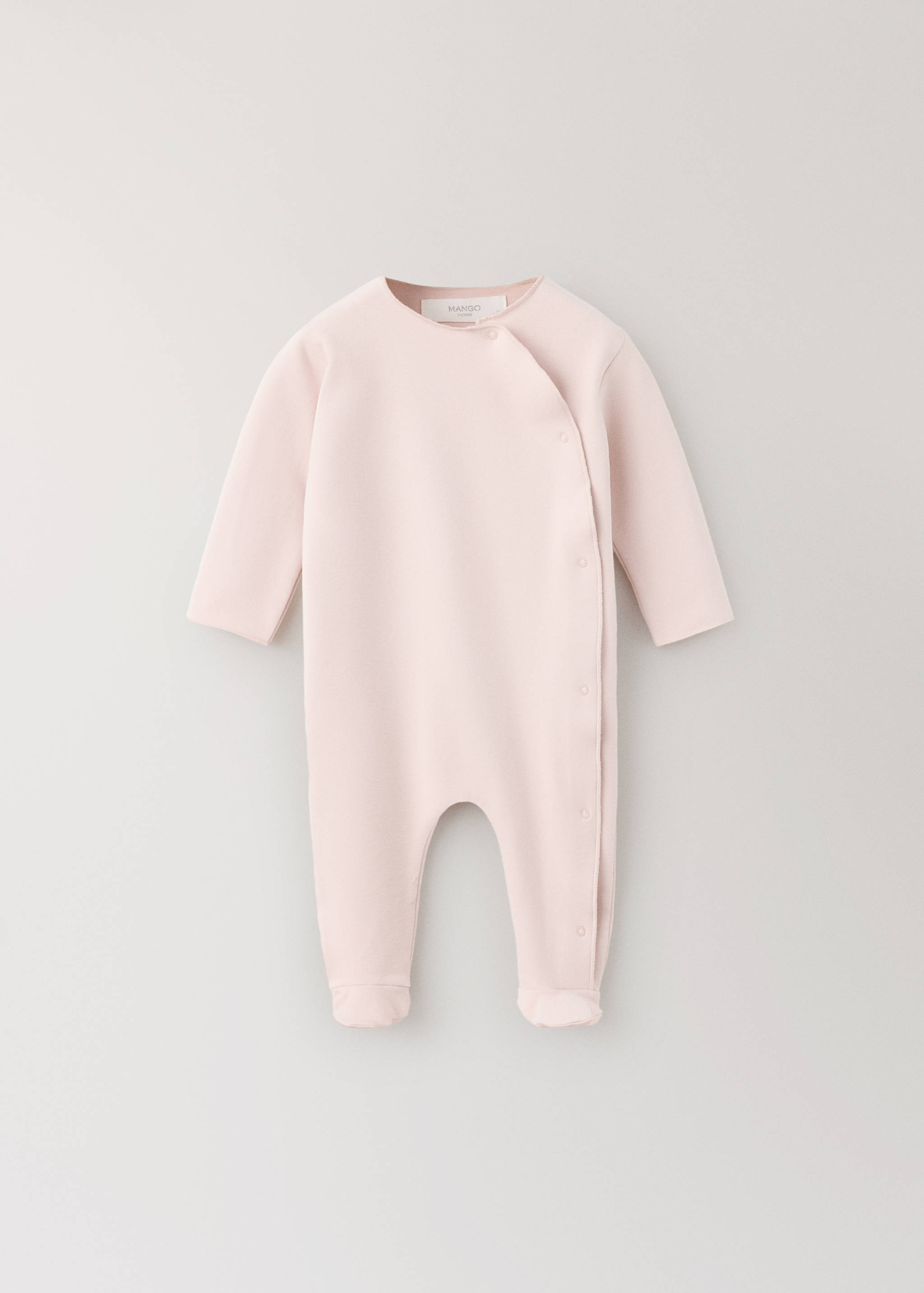 Pale pink baby pyjama jumpsuit with long sleeves and asymmetric snap fastening.