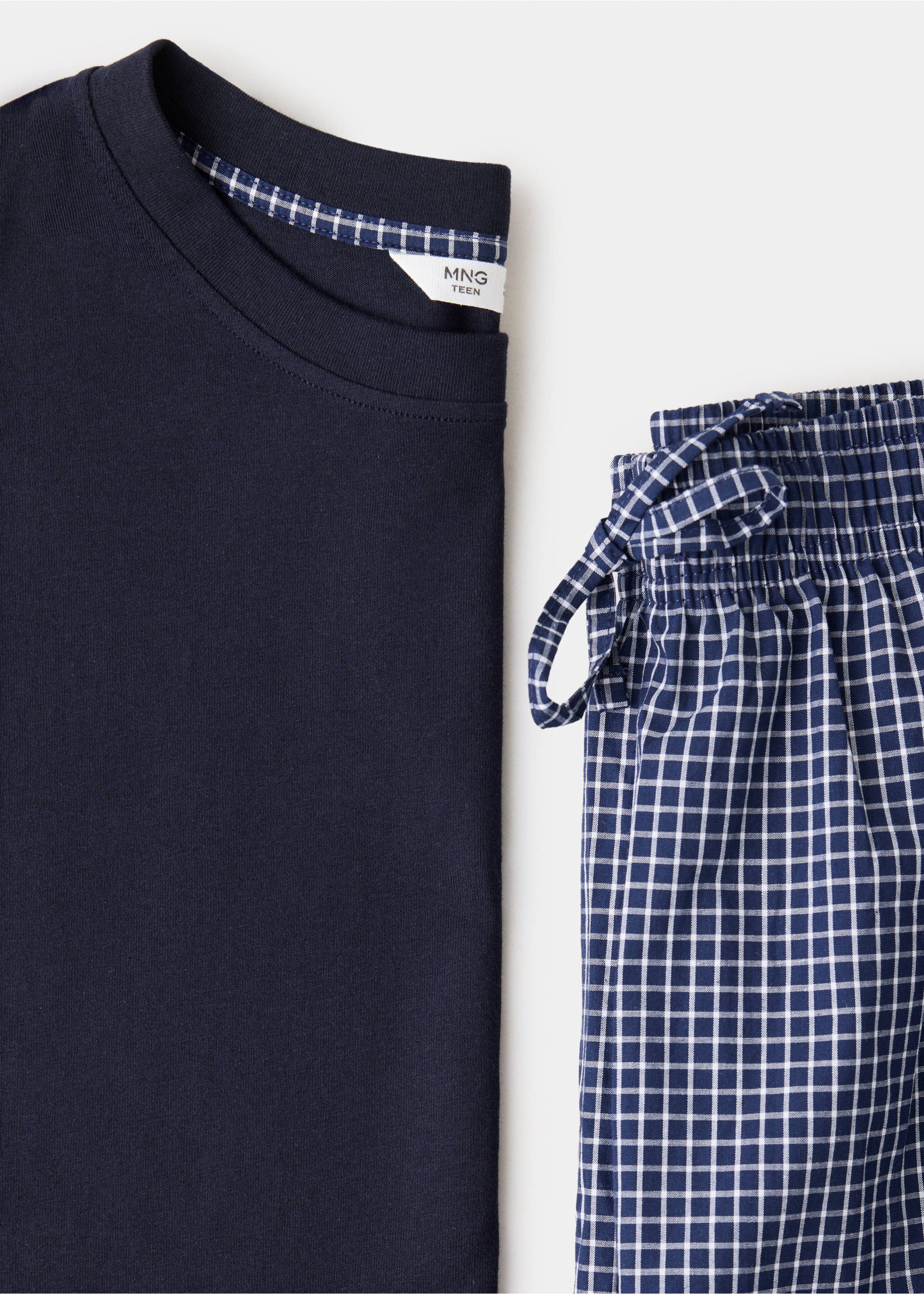Navy blue pyjama set featuring a plain t-shirt and grid-check trousers with an elasticated waistband., Navy. Ref: 37065855-00.