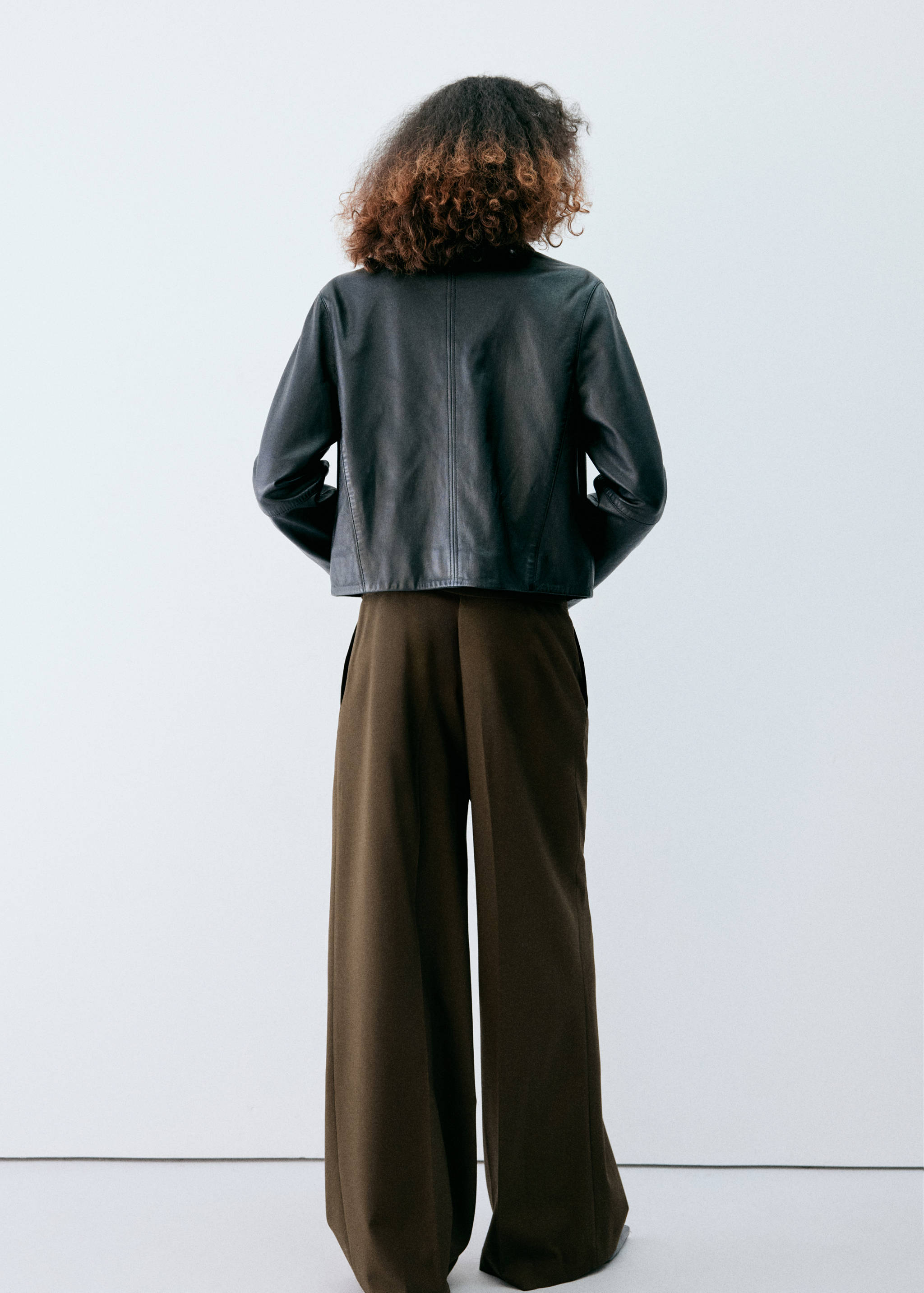 Dark olive-green wide-leg trousers, shown from the back view.