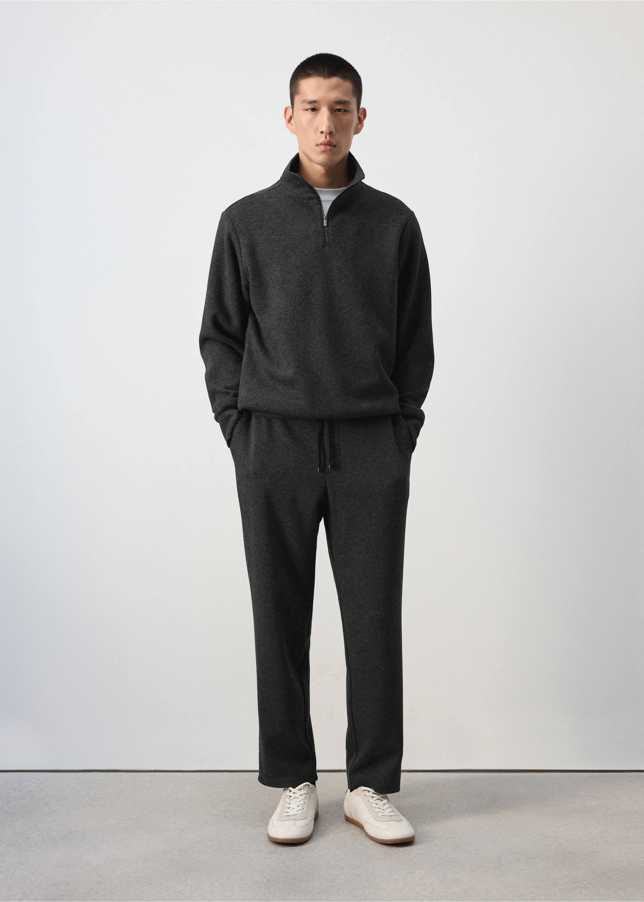 Charcoal grey joggers with a drawstring waist, worn with a matching quarter-zip sweatshirt., Dark Grey. Ref: 37065996-00.