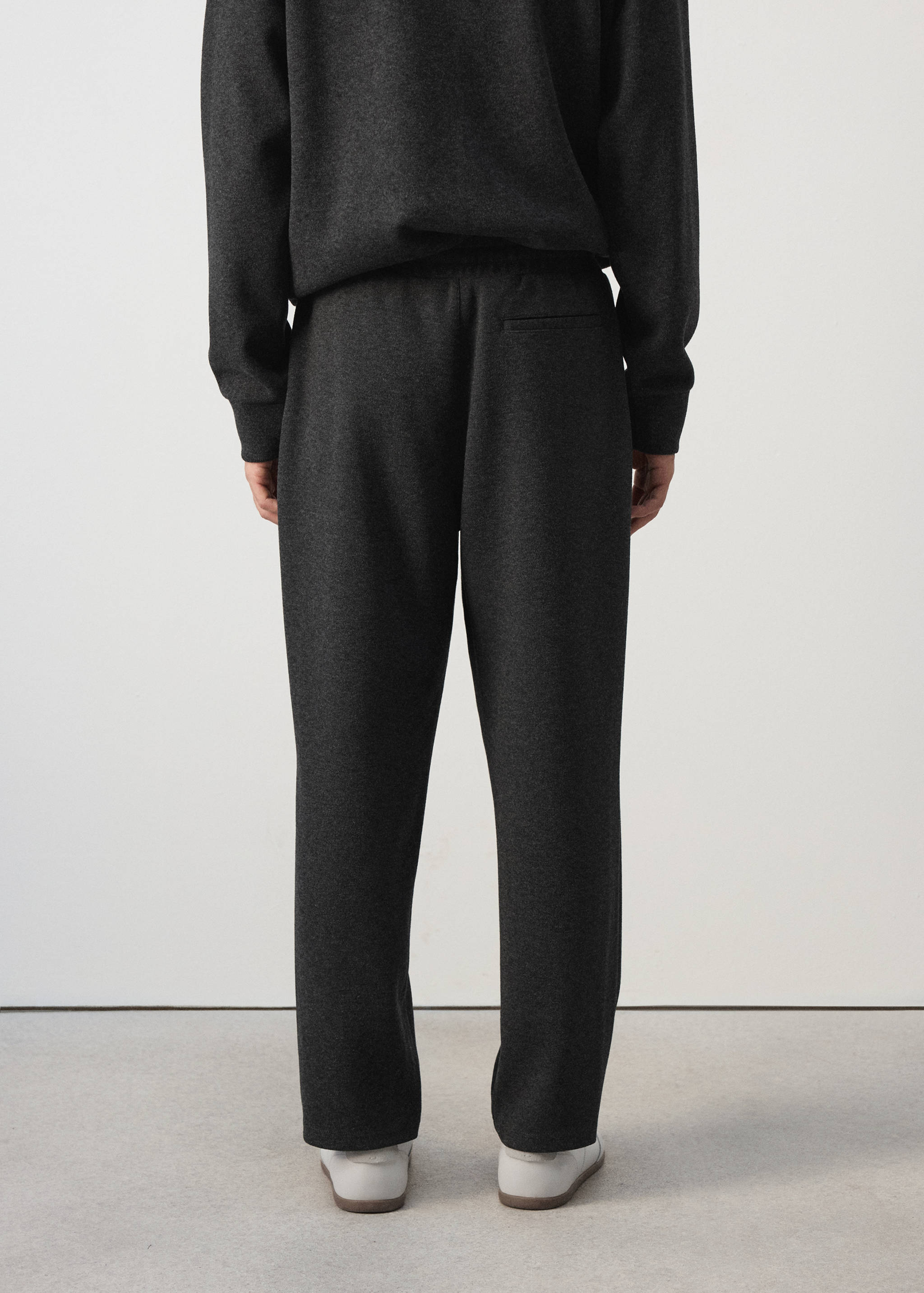 Dark grey joggers from the back, featuring an elasticated waist and a back pocket.