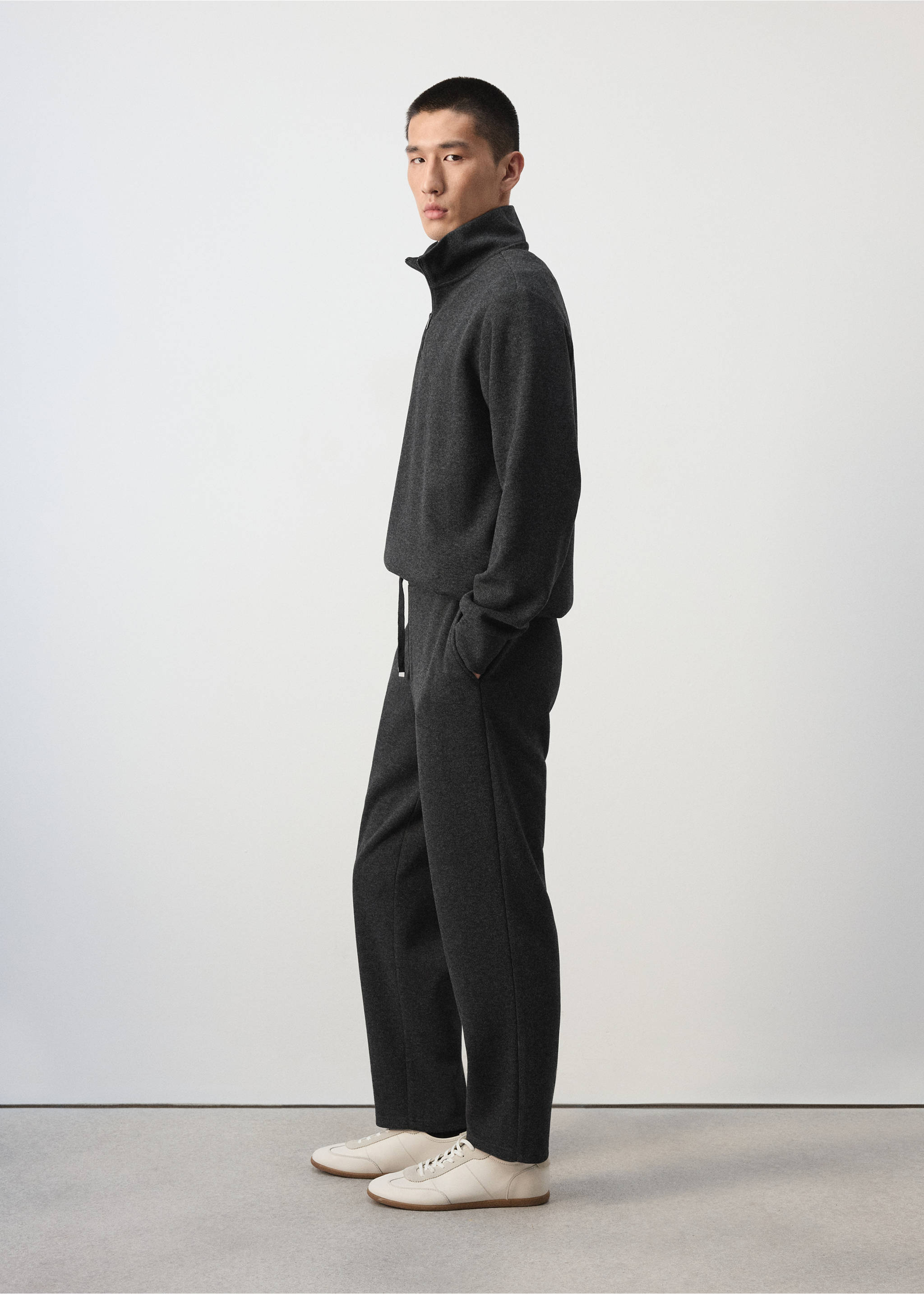 Dark charcoal grey joggers with a drawstring waist, worn with a matching sweatshirt., Dark Grey. Ref: 37065996-00.