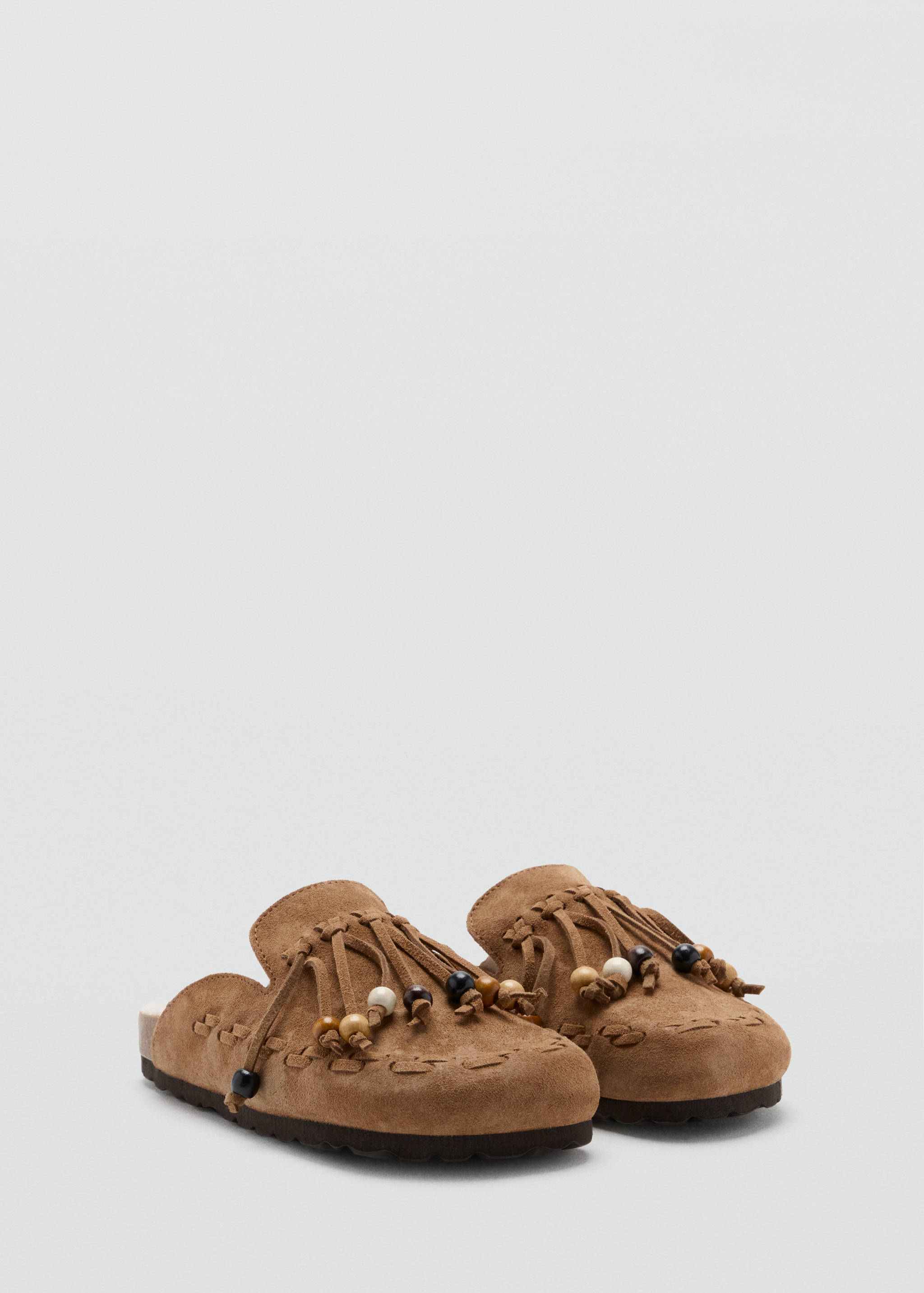 Brown suede children's clogs with fringe and wooden bead details.