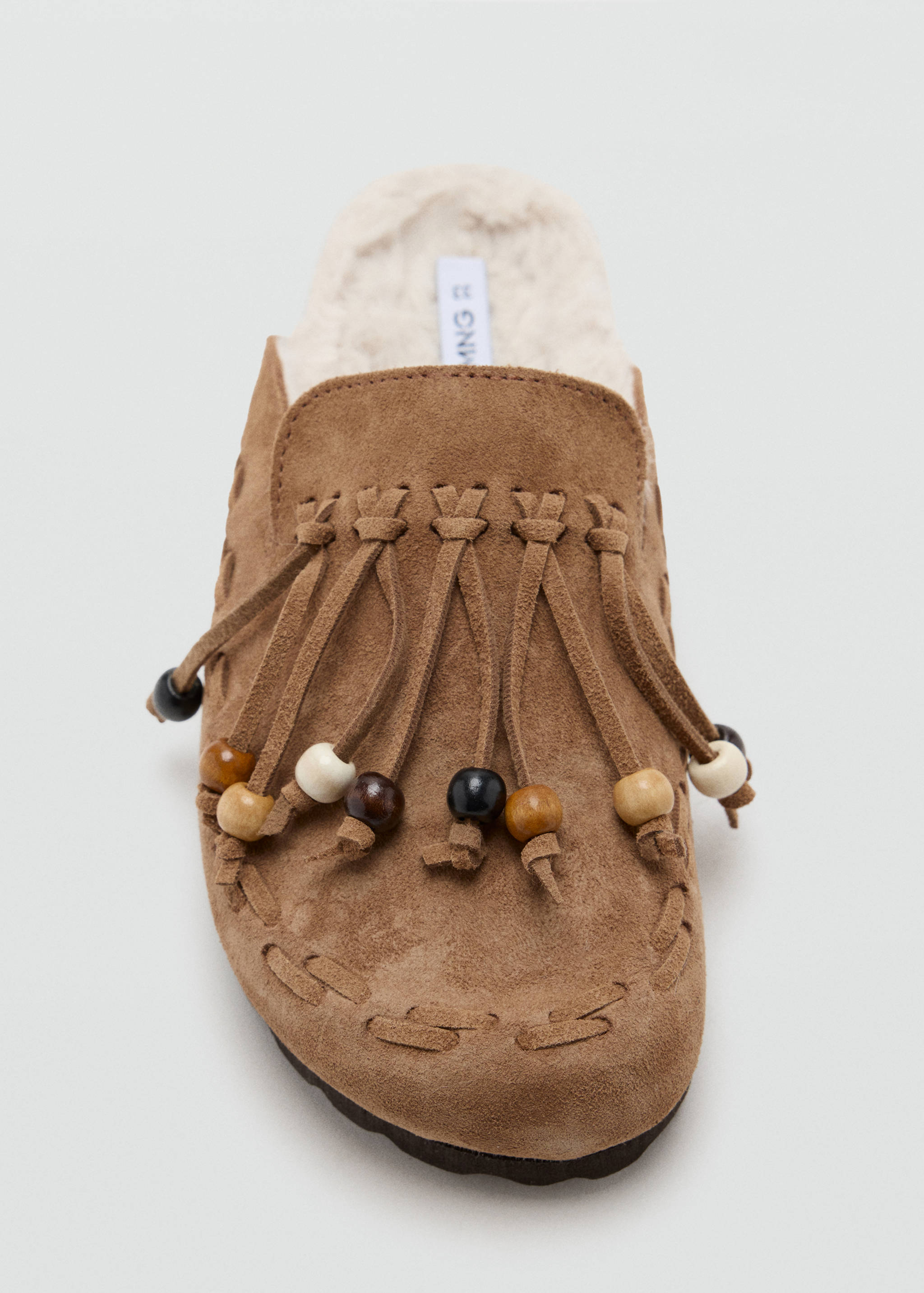 Brown suede kids' clog shoe with fringing, wooden beads, and faux-shearling lining.