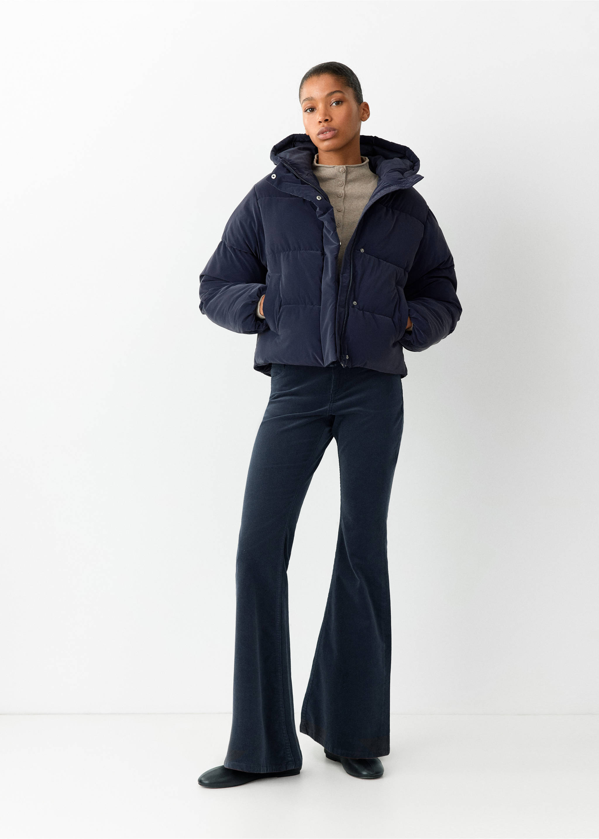Dark blue flared corduroy trousers worn with a quilted puffer jacket., Navy. Ref: 37066724-00.