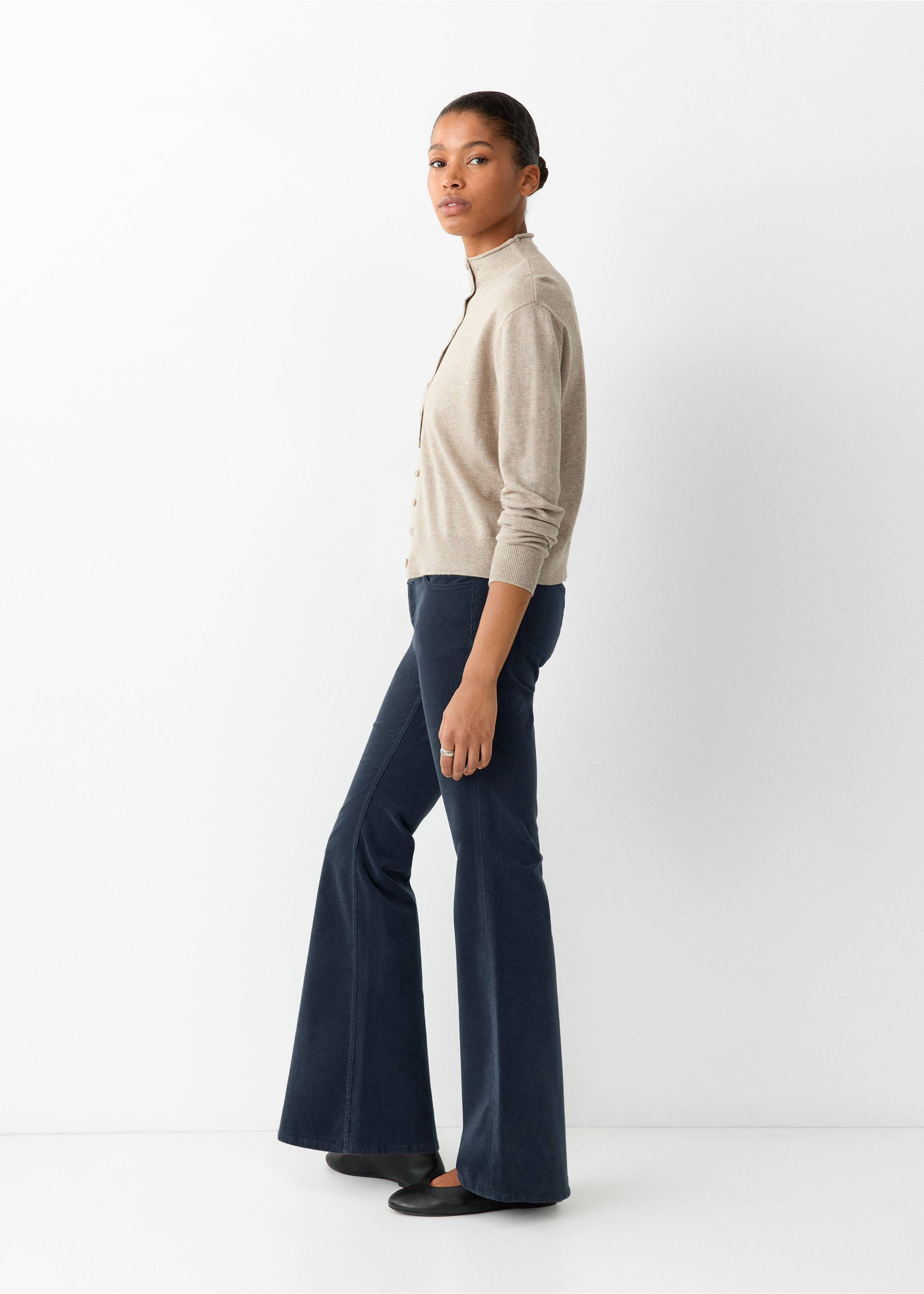 Dark blue flared trousers worn with a beige high-collar cardigan., Navy. Ref: 37066724-00.