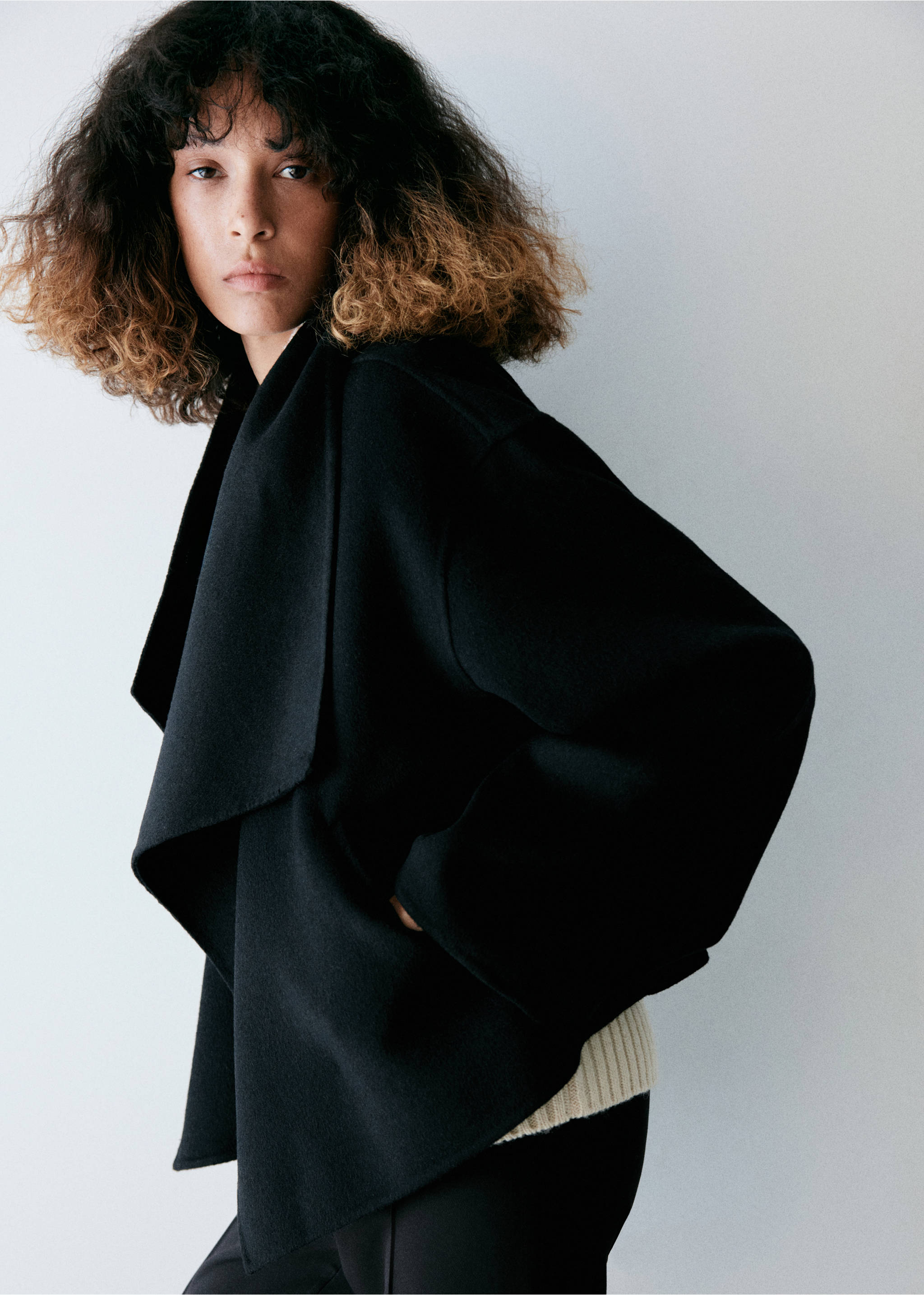 Black jacket with a draped collar and wide sleeves worn with a ribbed sweater., Black. Ref: 37066740-00.