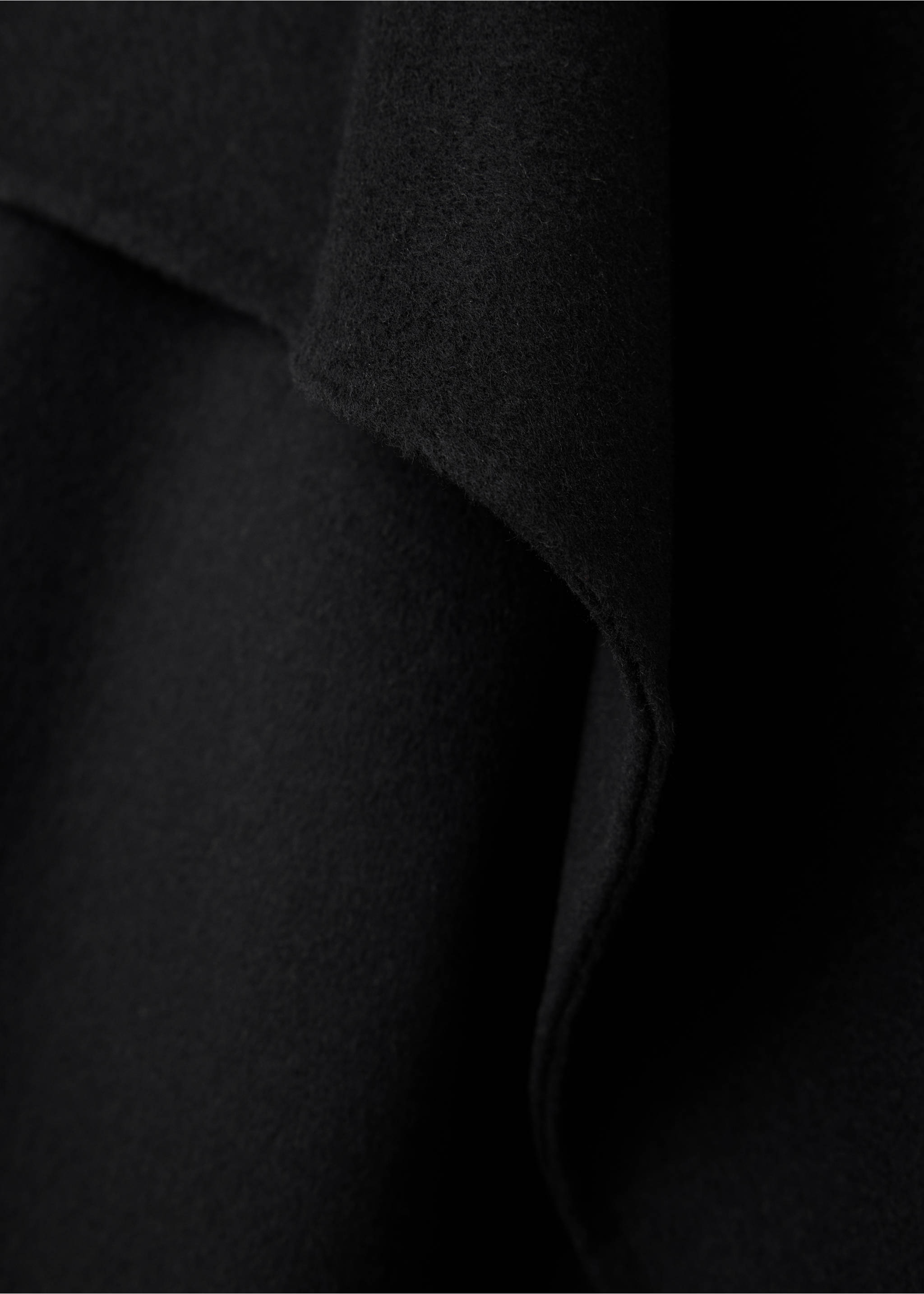 Close-up of a black jacket draped lapel., Black. Ref: 37066740-00.