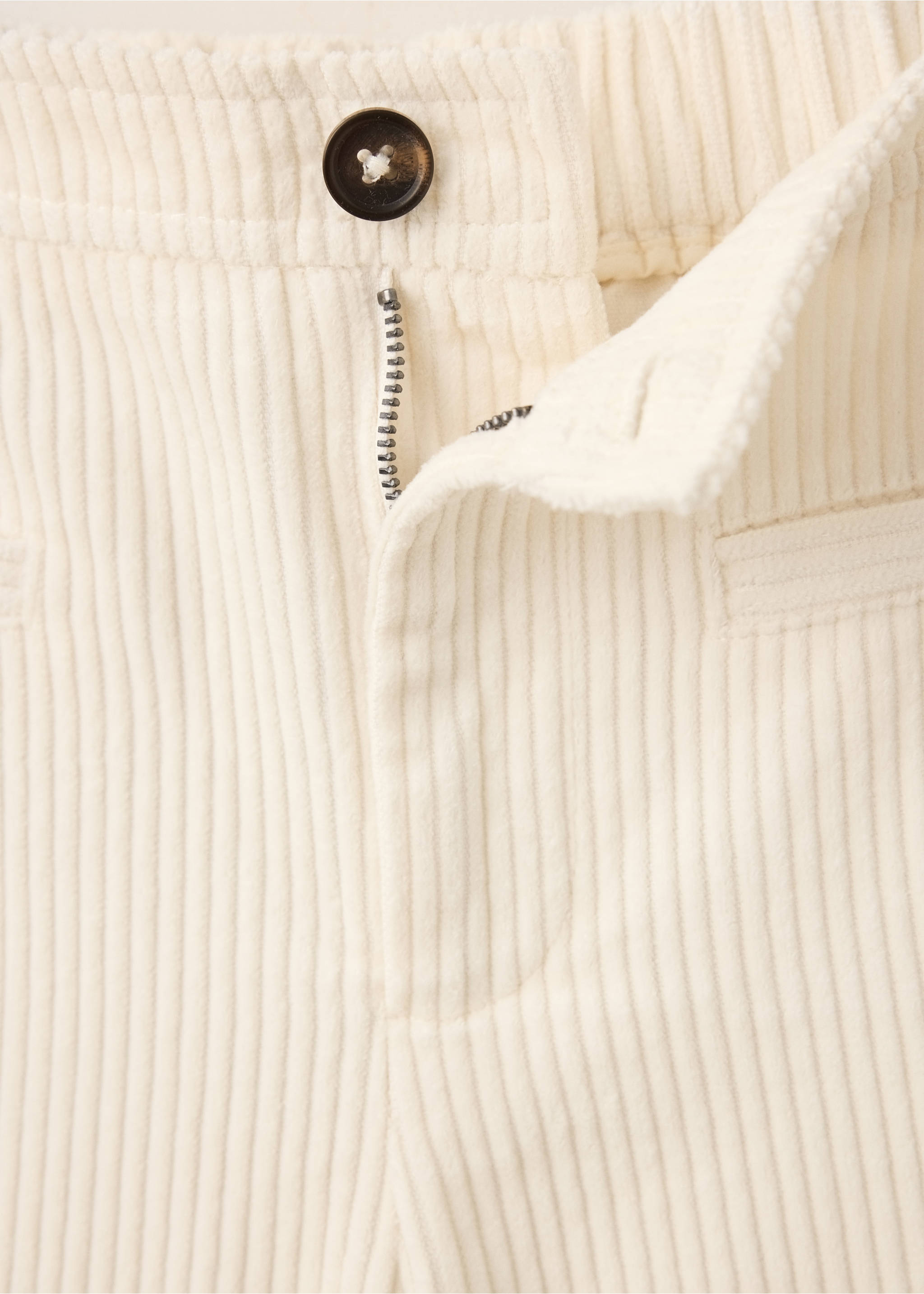 Close-up of off-white corduroy trousers with a button and zipper fly., Ecru. Ref: 37067123-00.