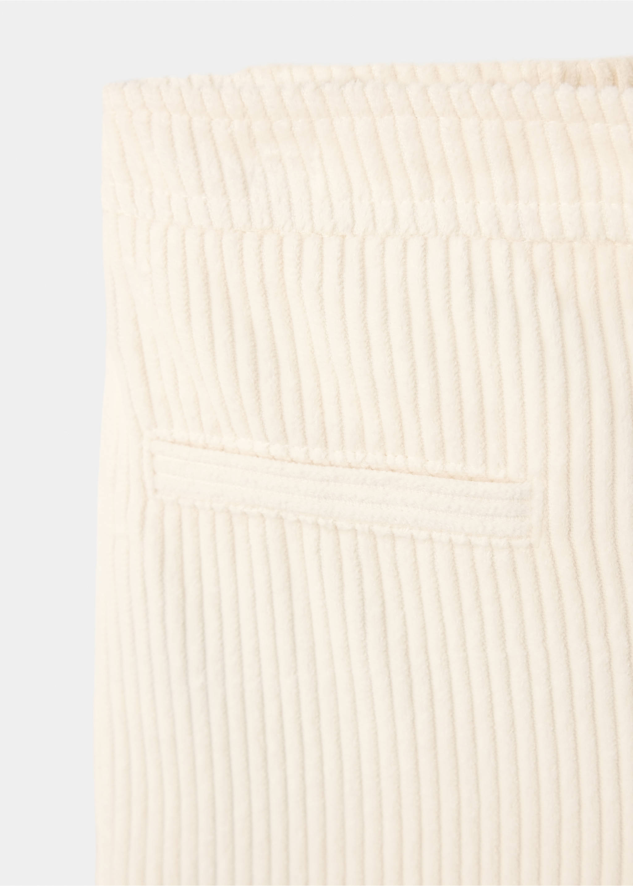 Close-up of off-white corduroy trousers showing fabric texture and pocket detail., Ecru. Ref: 37067123-00.