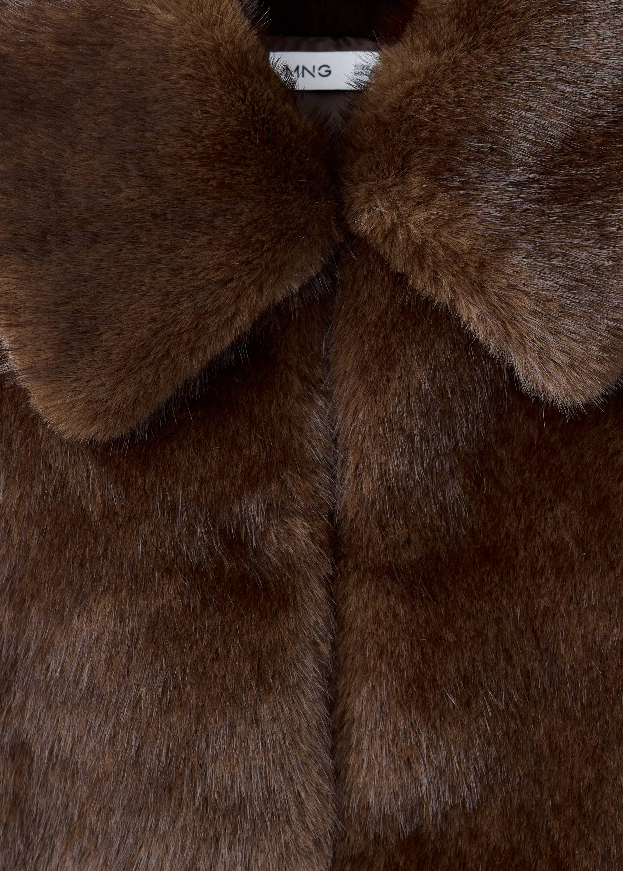 Brown faux-fur coat collar close-up.