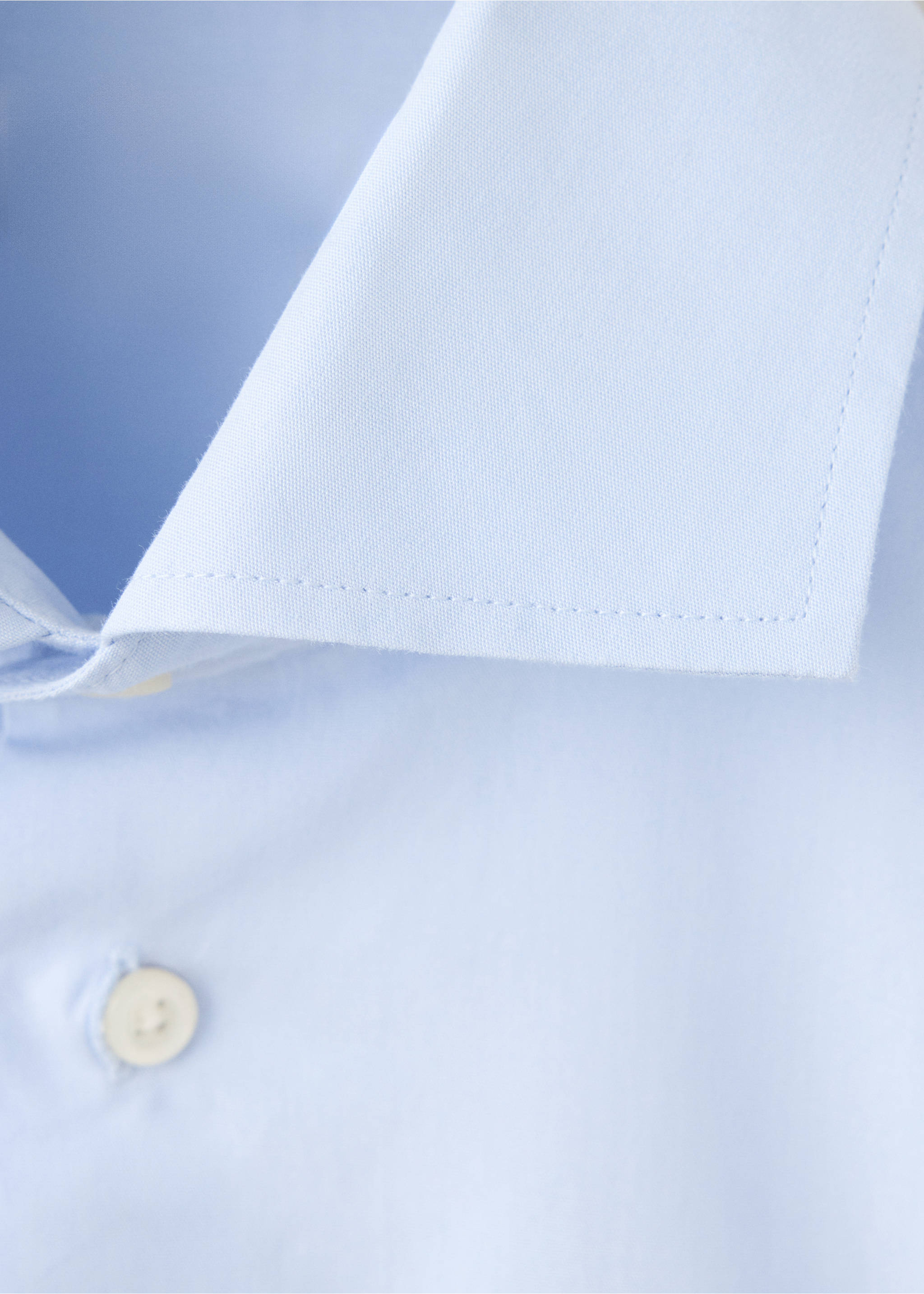 Close-up of a light blue shirt collar and button detail., Sky Blue. Ref: 37067134-00.