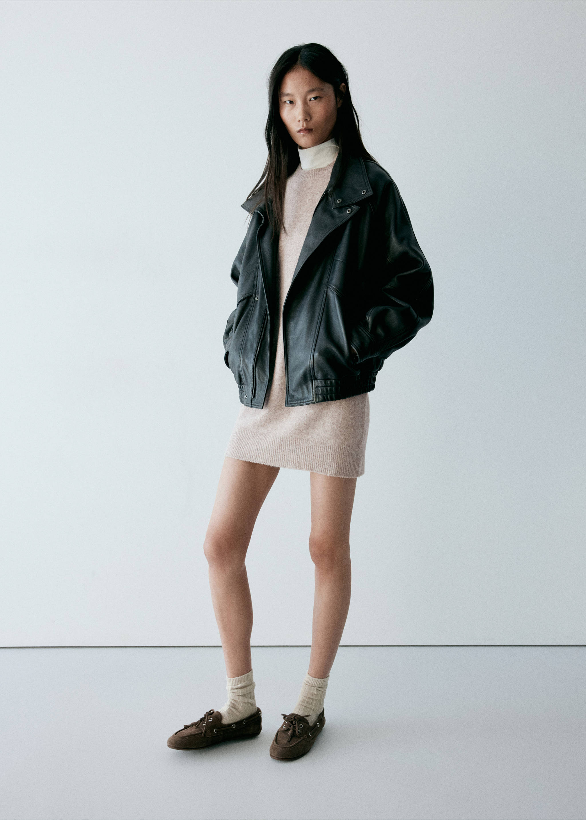 Short beige knitted dress styled with an oversized black leather jacket and brown boat shoes., Light/Pastel Grey. Ref: 37067774-00.