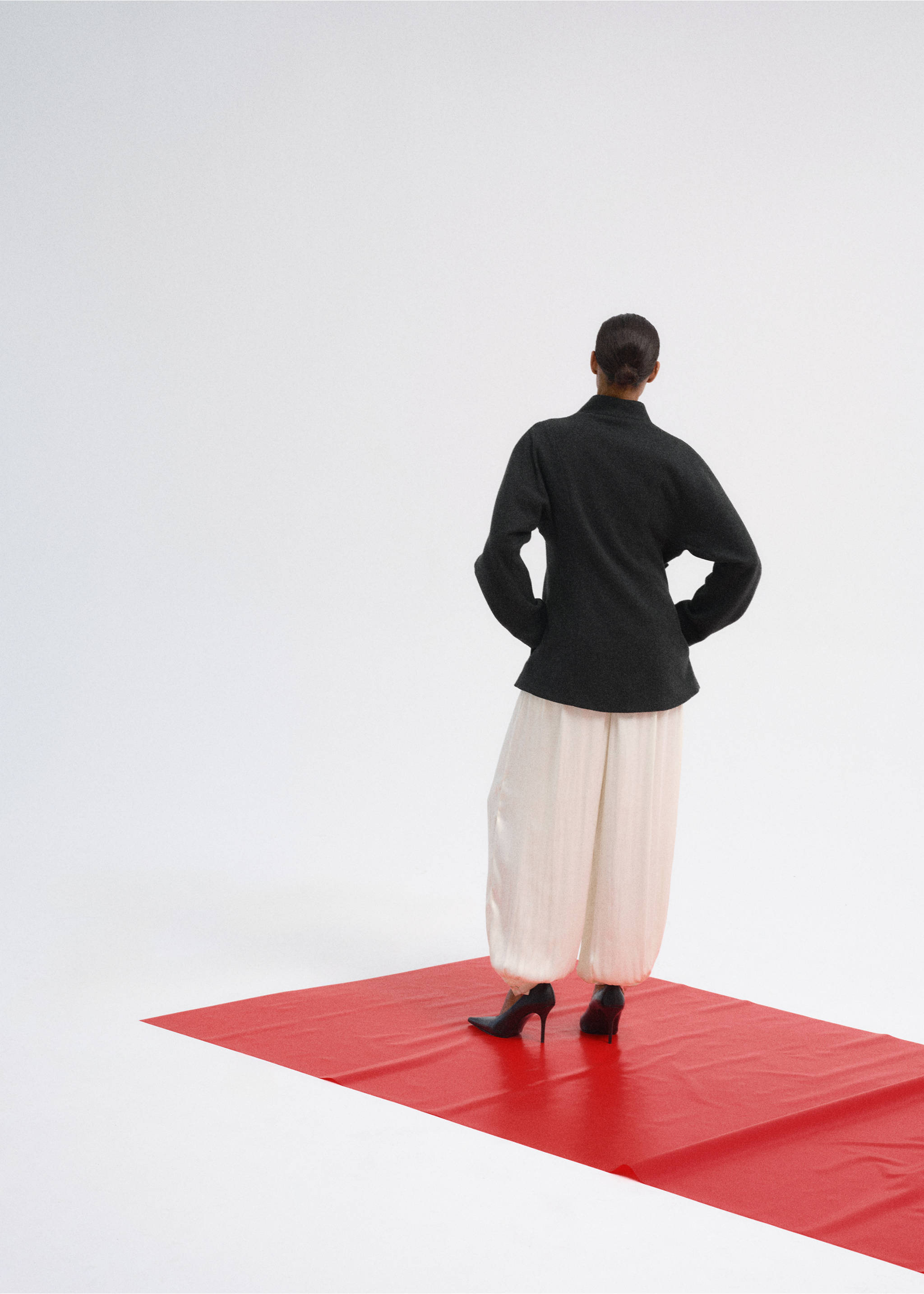 Dark grey coat seen from the back, worn with light trousers., Charcoal. Ref: 37067782-00.