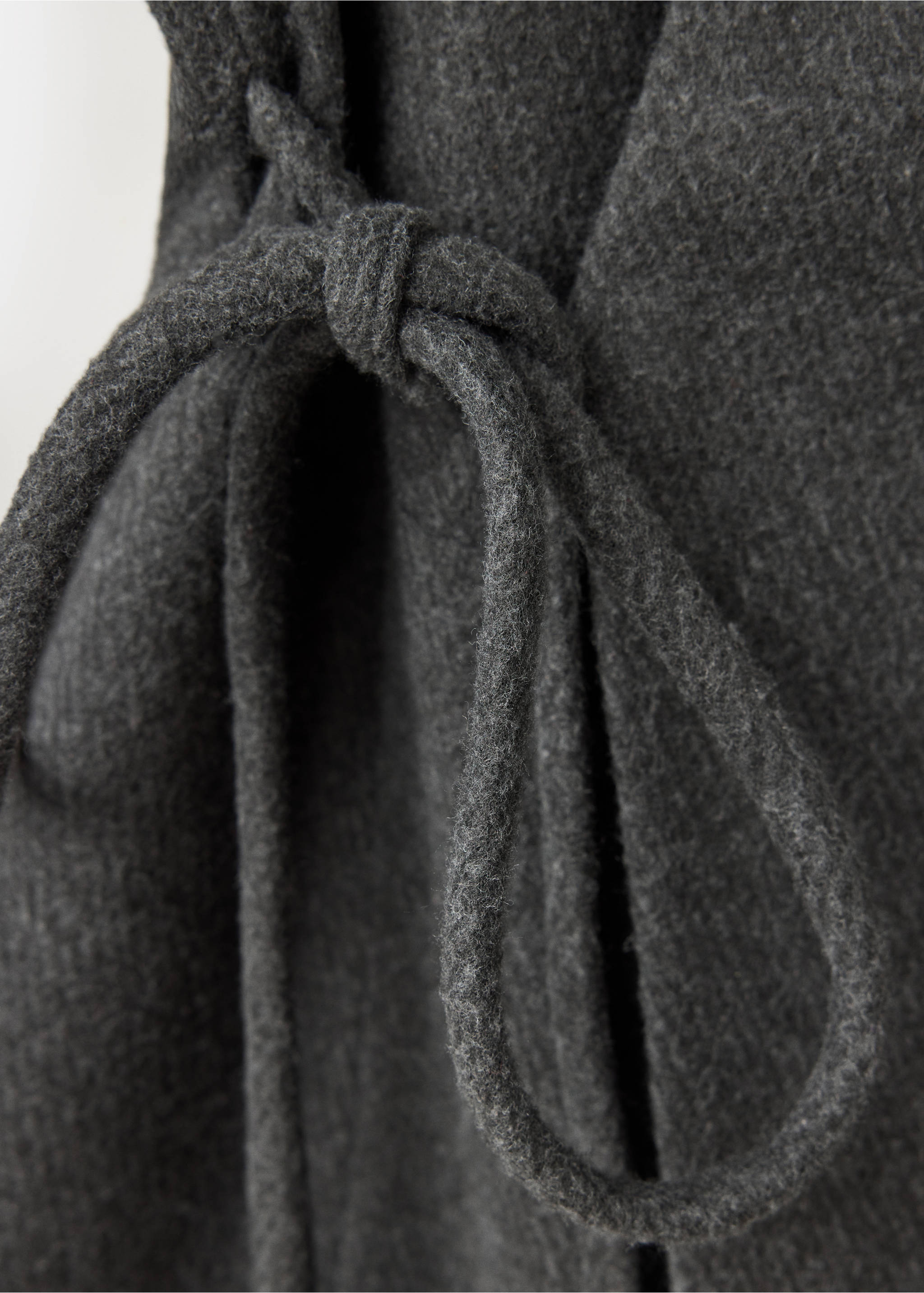 Close-up of a dark grey coat with a tied waist belt., Charcoal. Ref: 37067782-00.