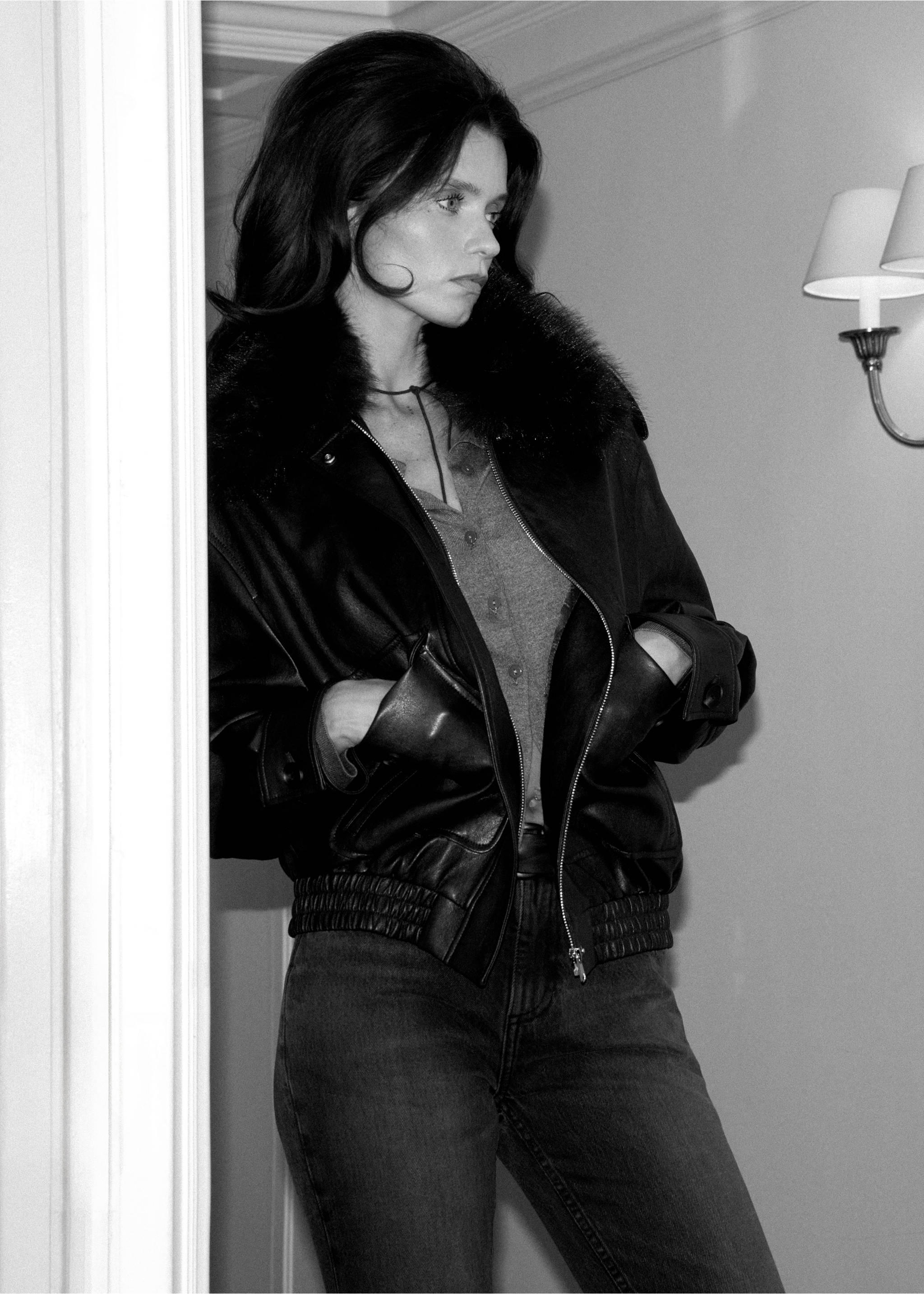 Black jacket with faux-fur collar and ribbed hem, worn by a model indoors., Chocolate. Ref: 37067784-00.