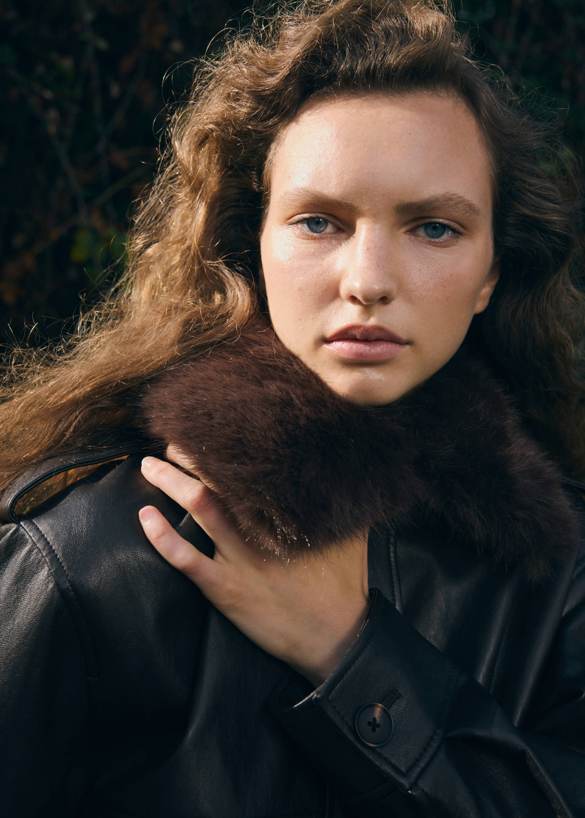 Dark brown jacket with a plush faux-fur collar.