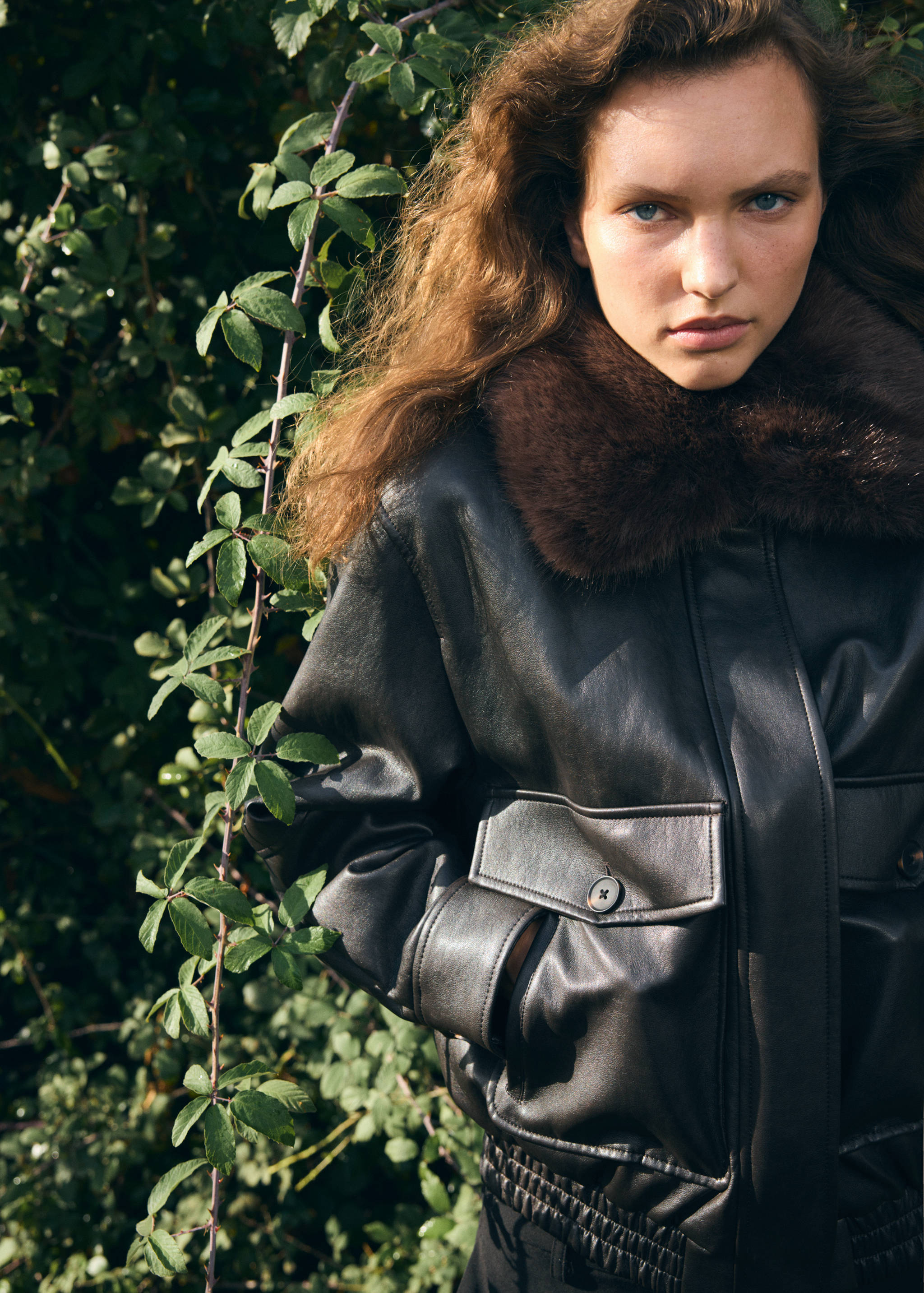 Dark brown leather jacket with a plush faux-fur collar.