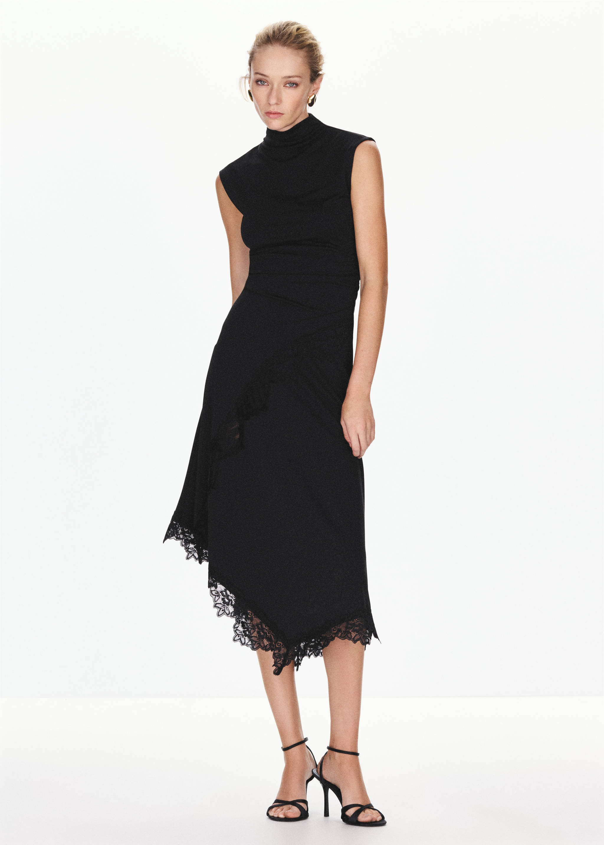 Sleeveless black midi dress with high neck and asymmetrical lace-trim hem.