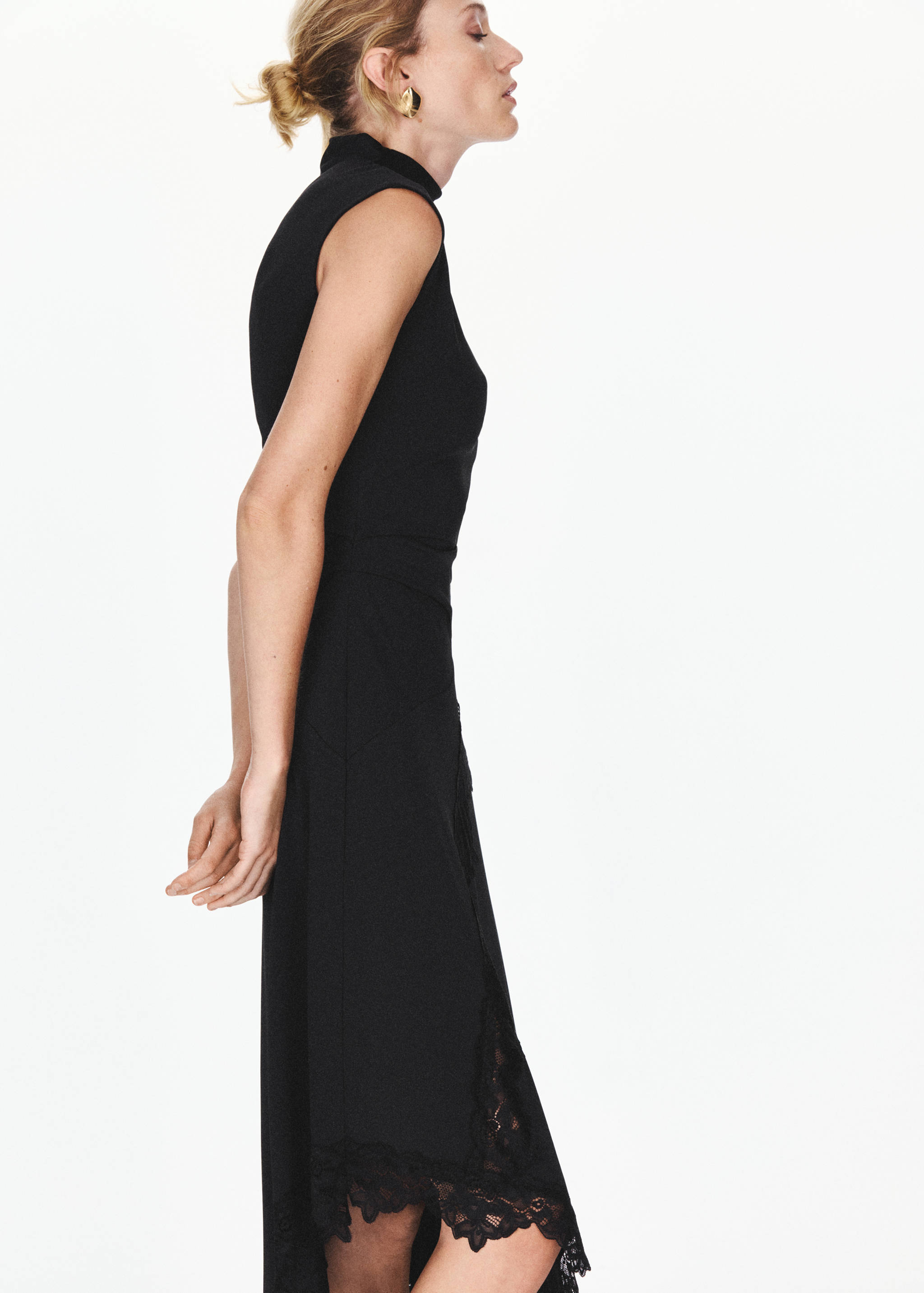 Black sleeveless dress with high collar and lace hem