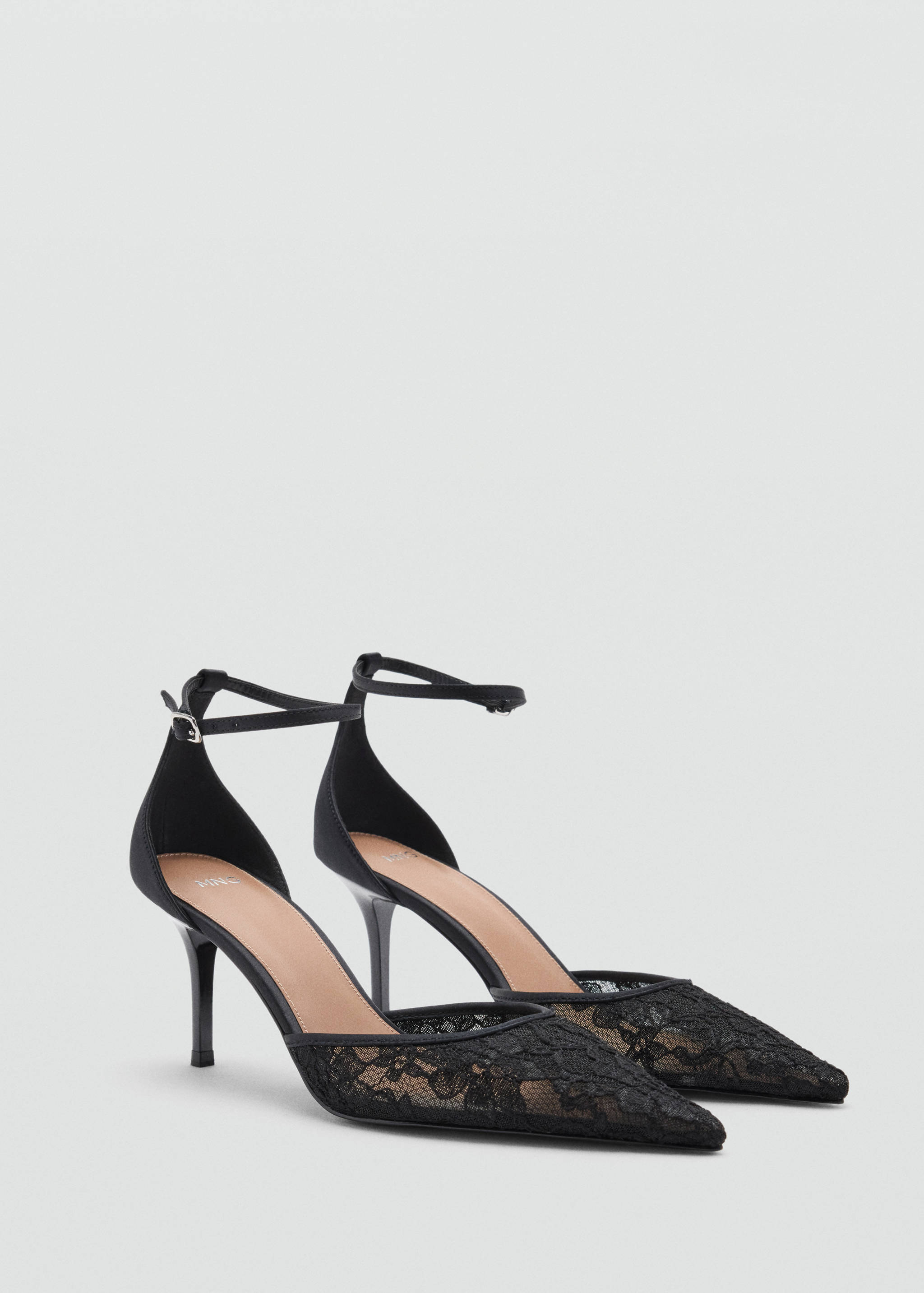 Black lace high-heeled shoes with a pointed toe and ankle strap.