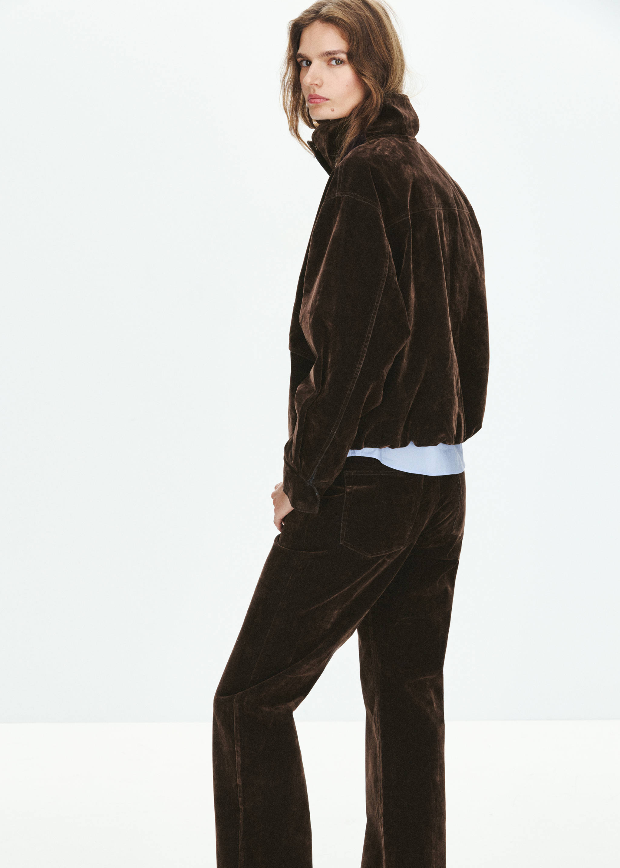 Dark brown jacket with high collar shown from the back.