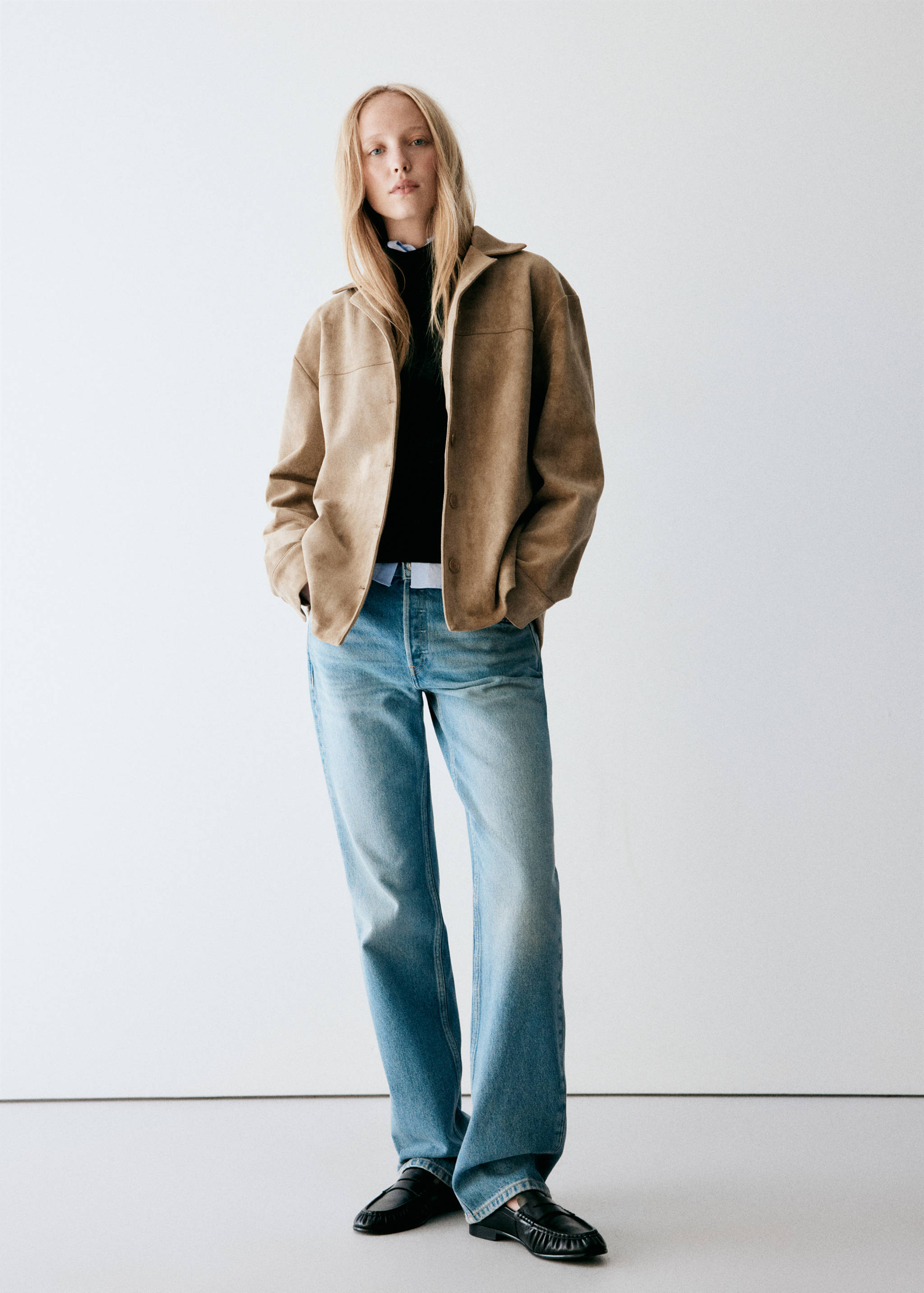 Brown faux-suede overshirt styled with a black top and blue jeans.