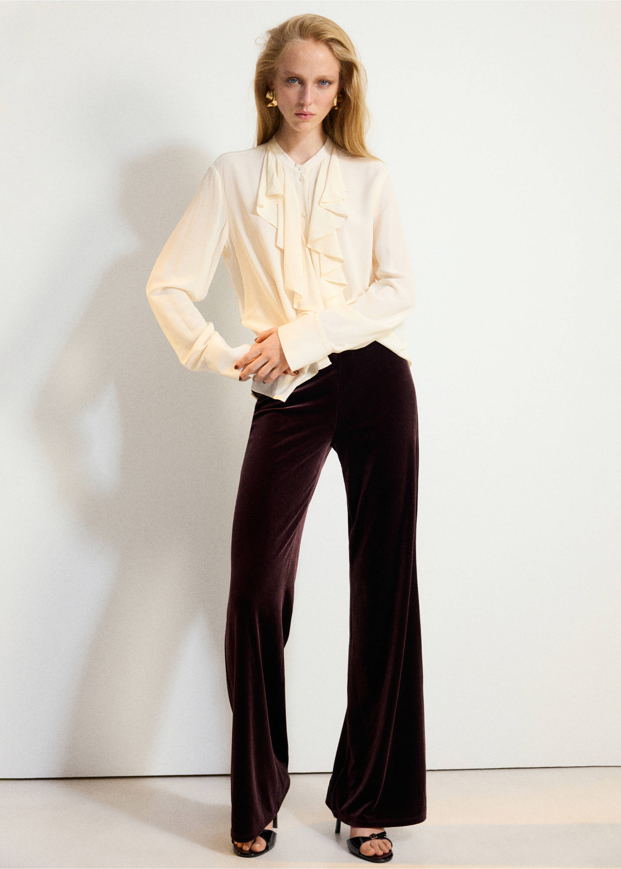 Dark plum velvet trousers worn with a cream ruffled blouse., Wine. Ref: 37067795-00.