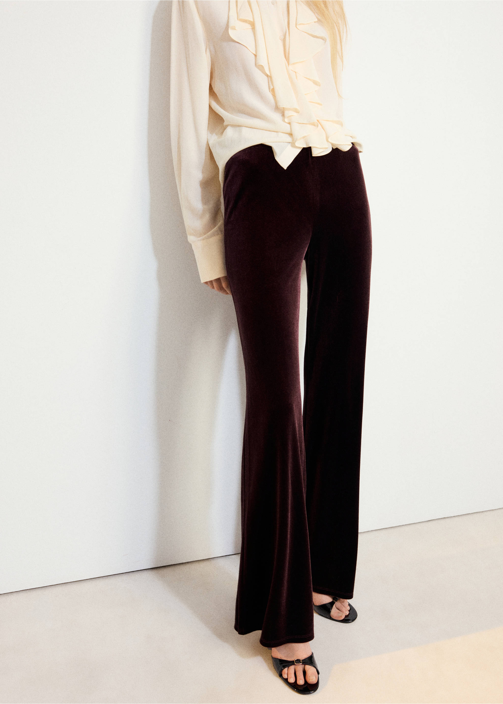 Maroon velvet flared trousers worn with a cream ruffled blouse., Wine. Ref: 37067795-00.