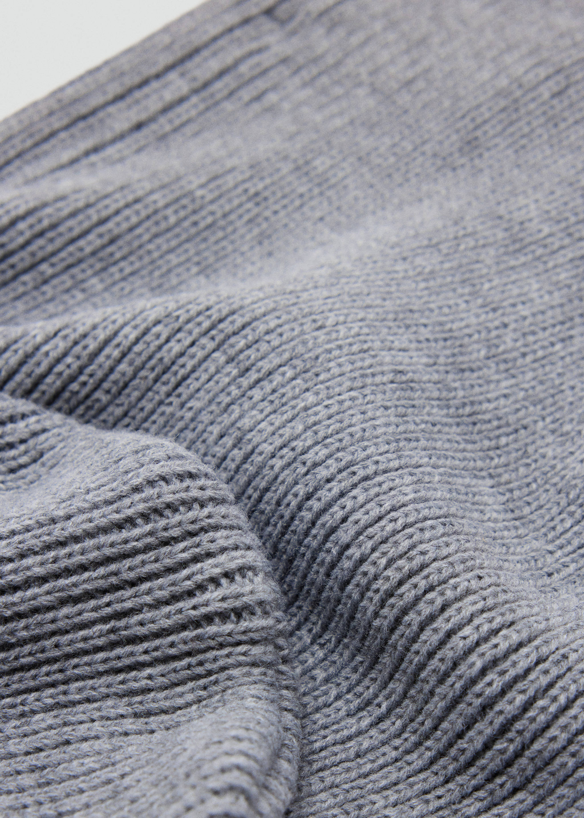 Grey hat knit detail showing the soft ribbed texture.