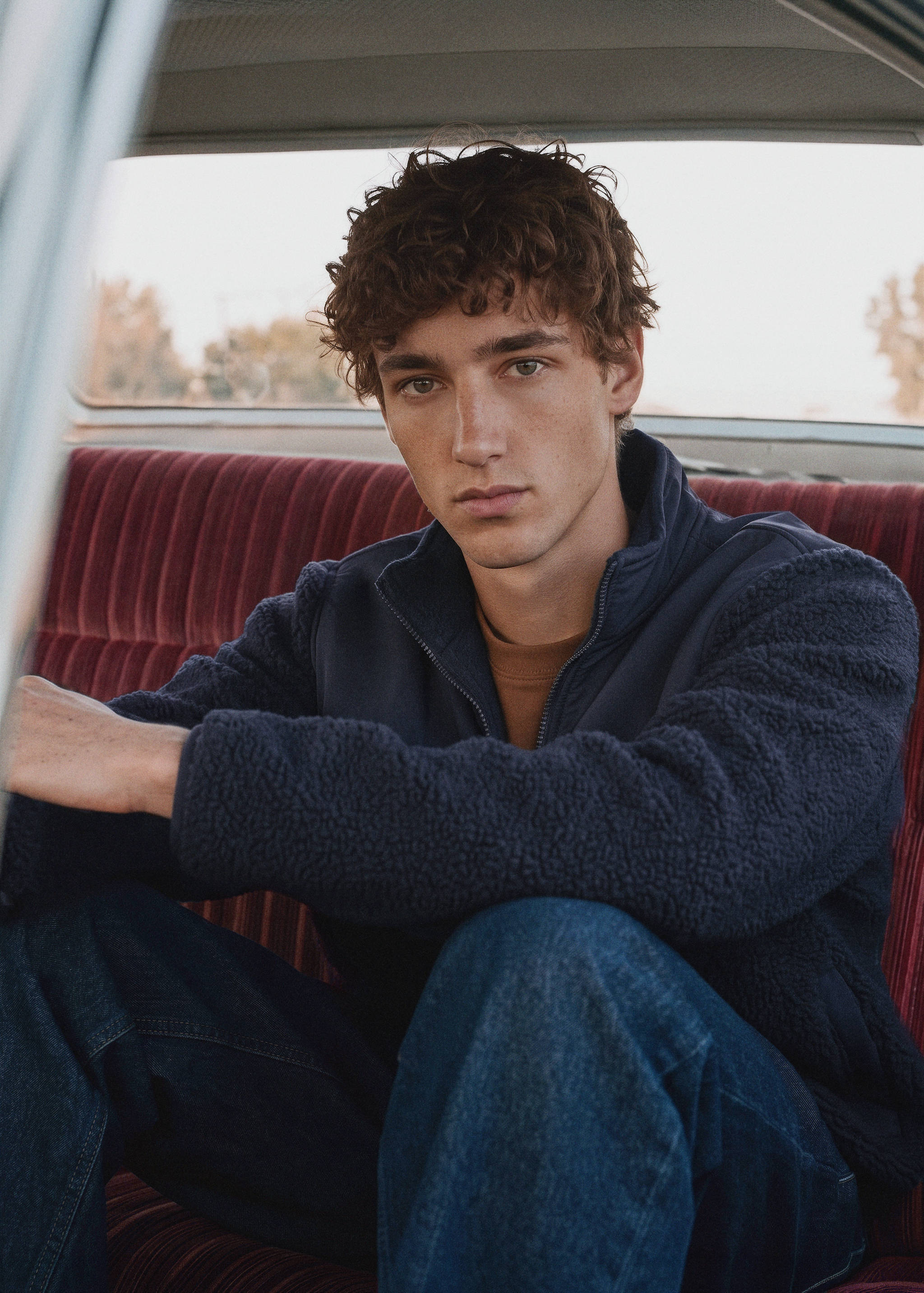 Navy blue zip-up jacket in textured fleece with smooth shoulder panels.
