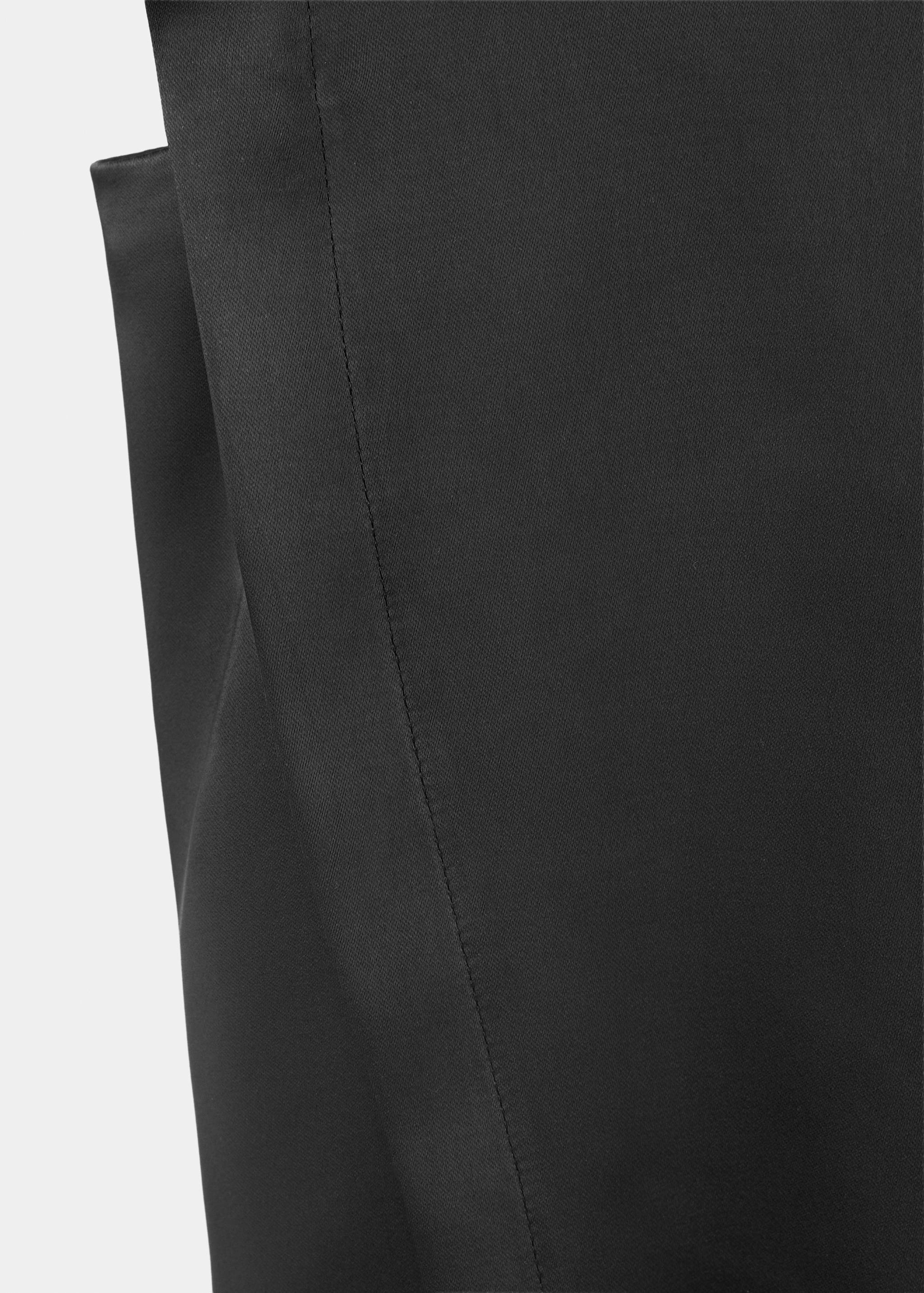 Close-up of the smooth black fabric and stitching on a blouse.