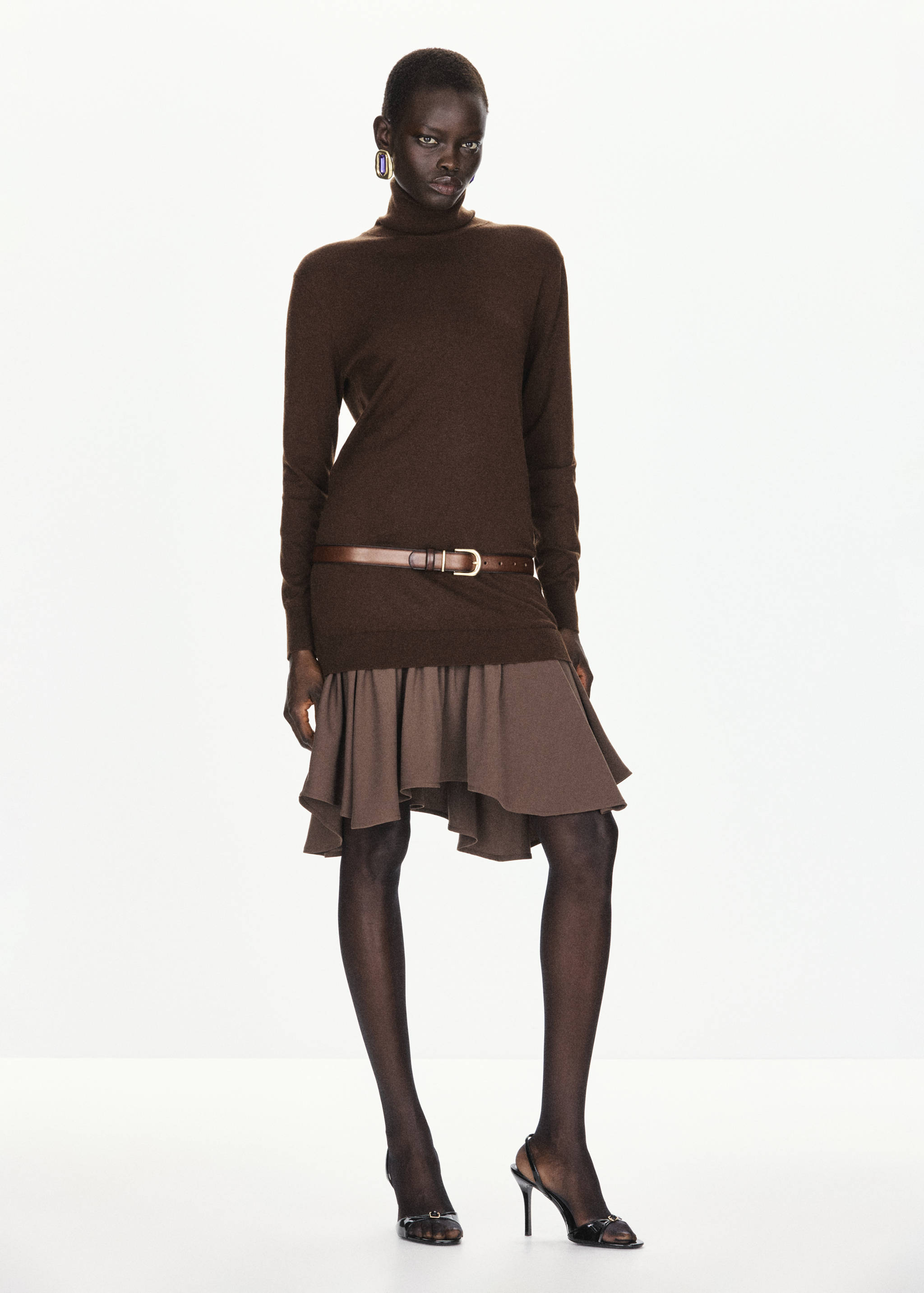 Brown knit turtleneck dress with a flared ruffle hem and thin belt.