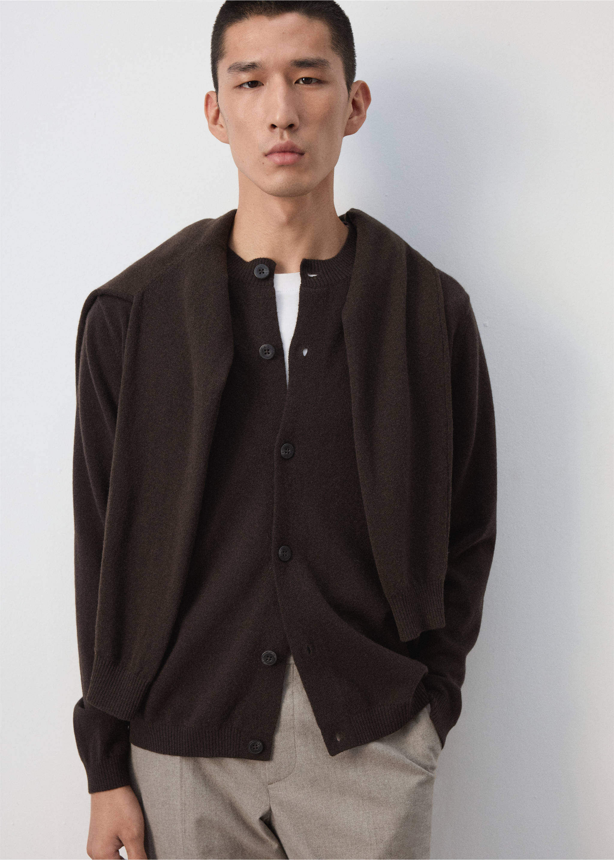 Dark brown knitted cardigan with buttons, worn with matching sweater draped over shoulders., Chocolate. Ref: 37067886-00.