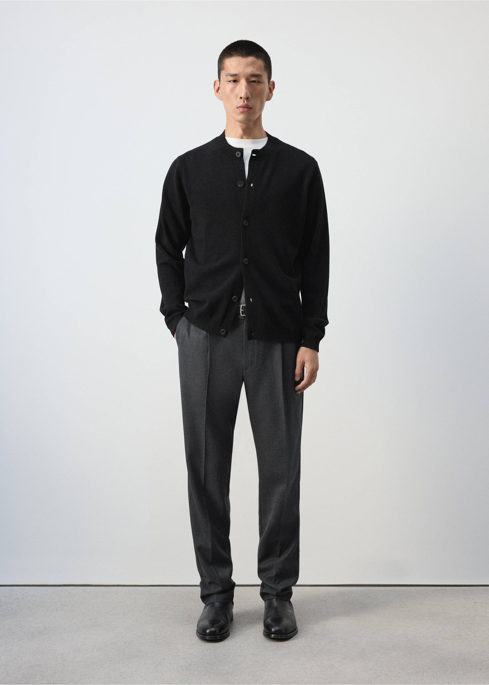 Black knit cardigan with a round collar and front buttons worn with grey trousers., Black. Ref: 37067886-00.