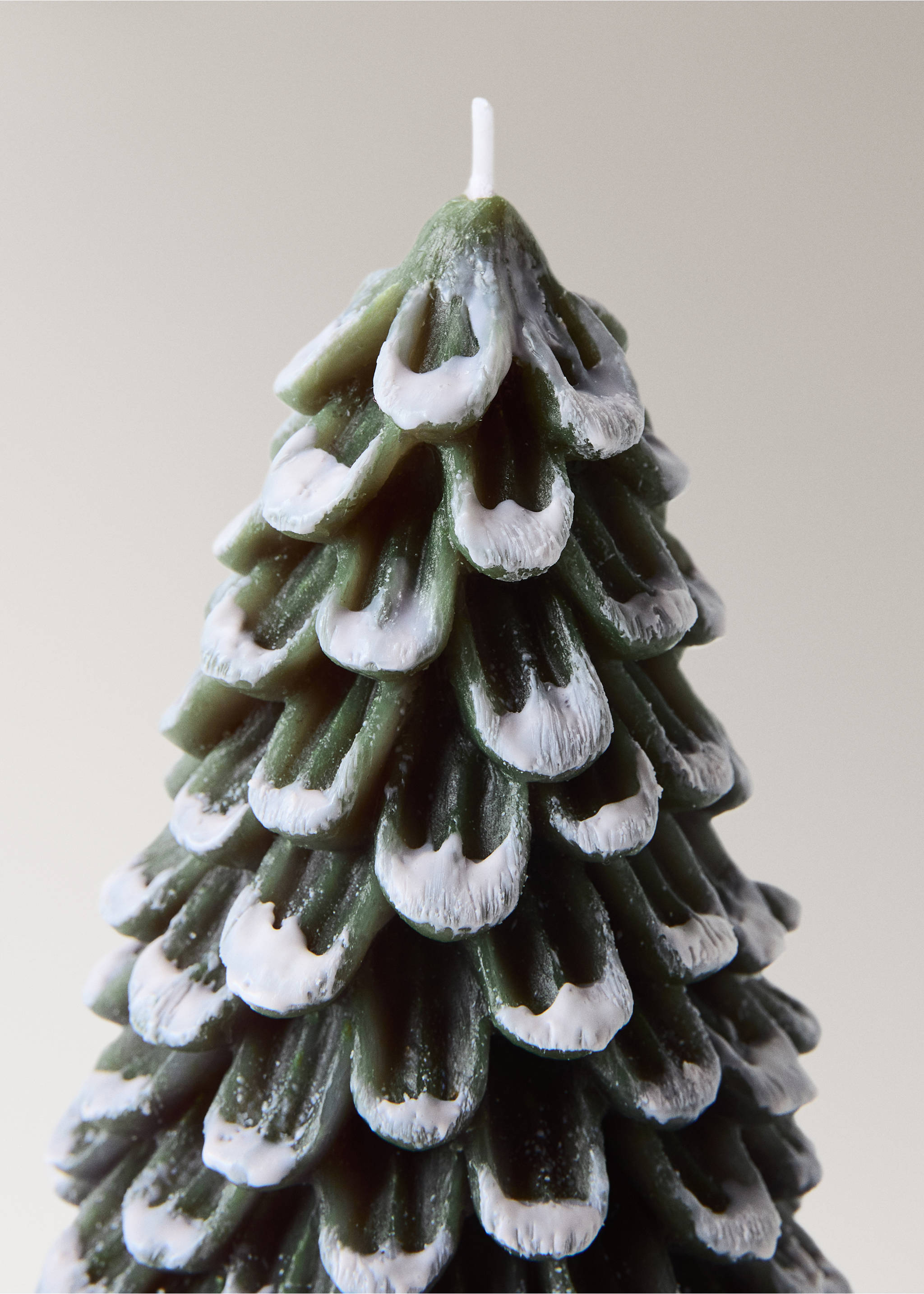 Close-up of a green pine-shaped candle with white-tipped details., Green. Ref: 37067892-00.