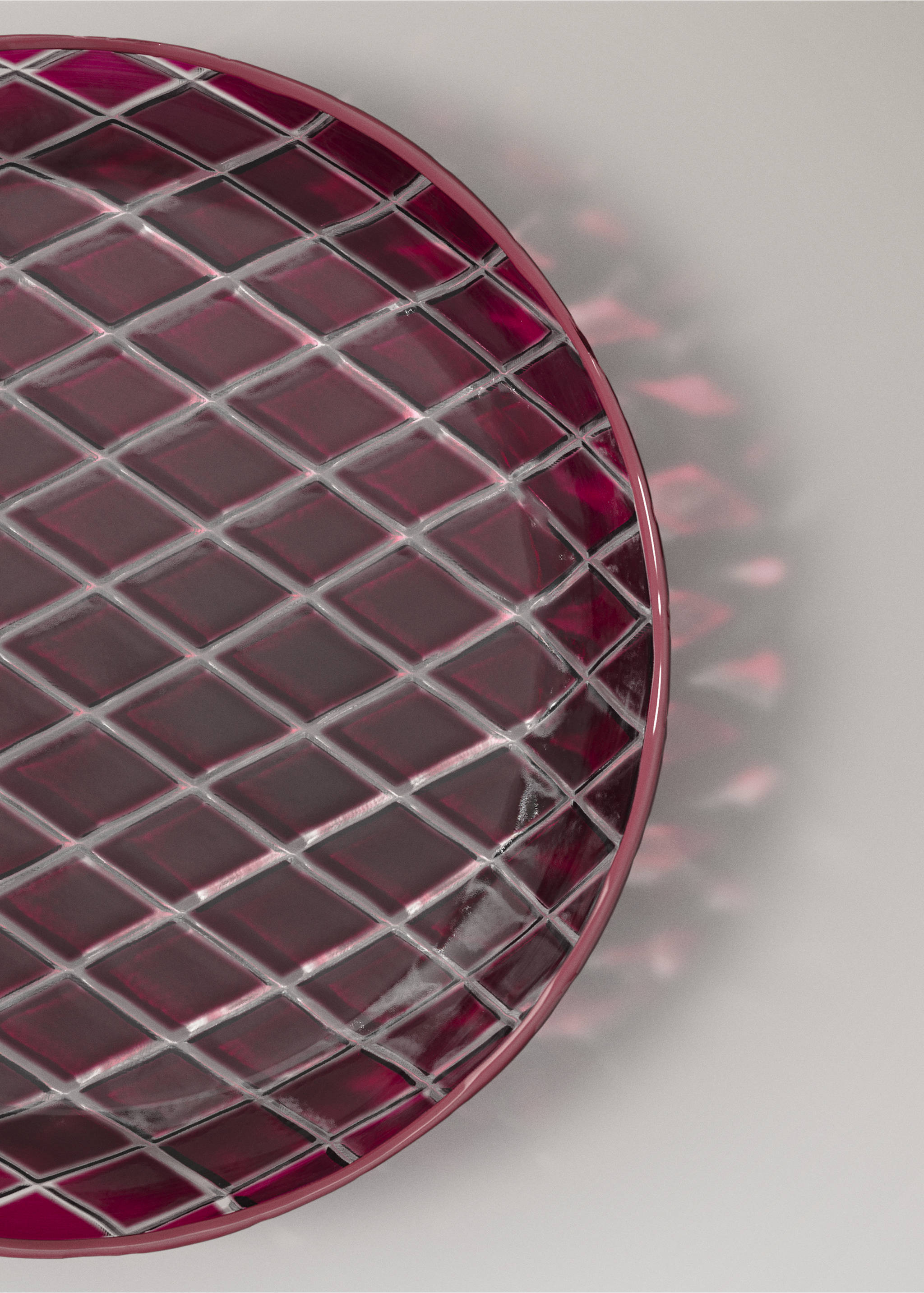 Close-up of a deep magenta glass plate with a faceted diamond pattern., Red. Ref: 37067901-00.