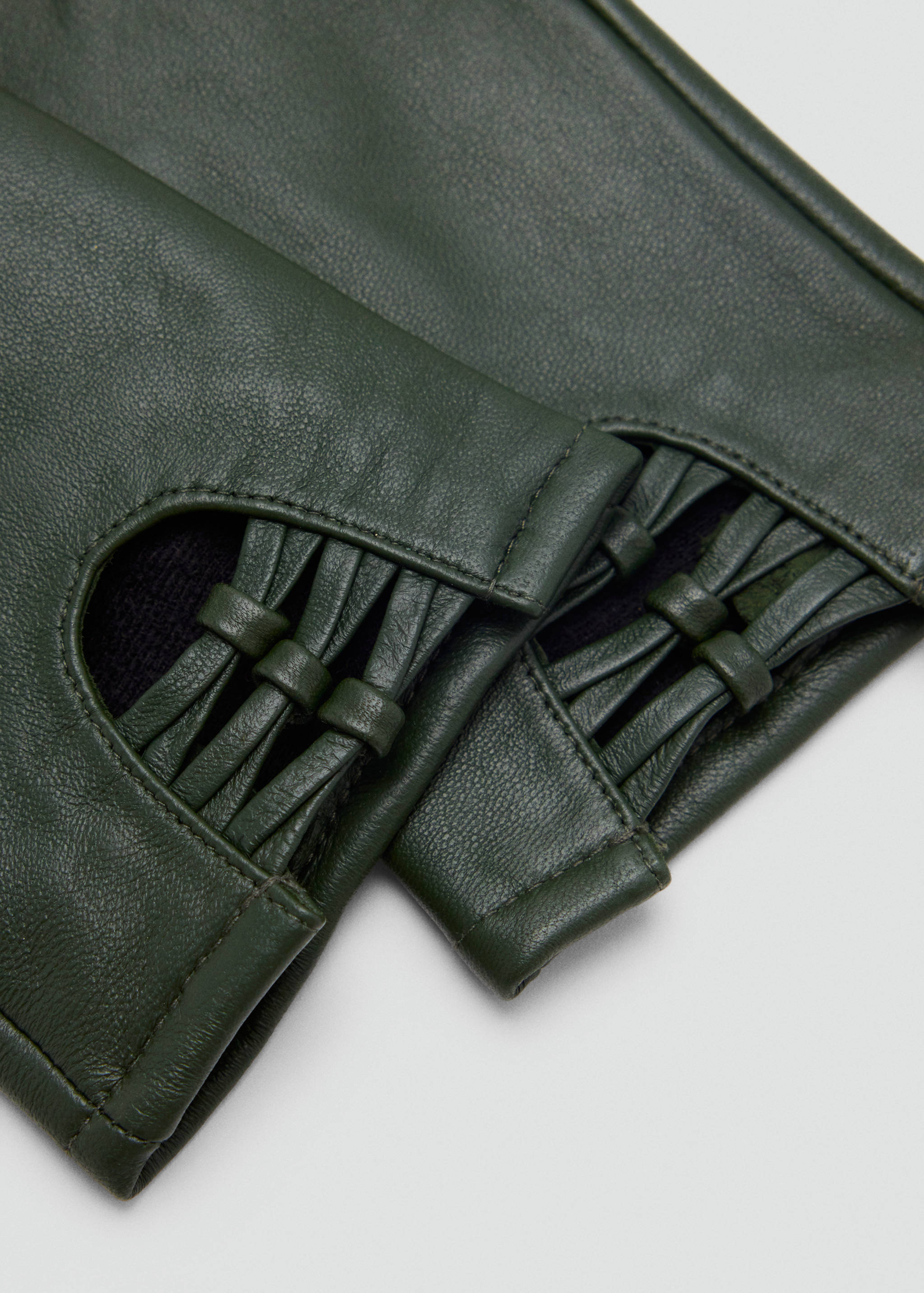 Dark green leather gloves with knotted strap cut-out cuffs