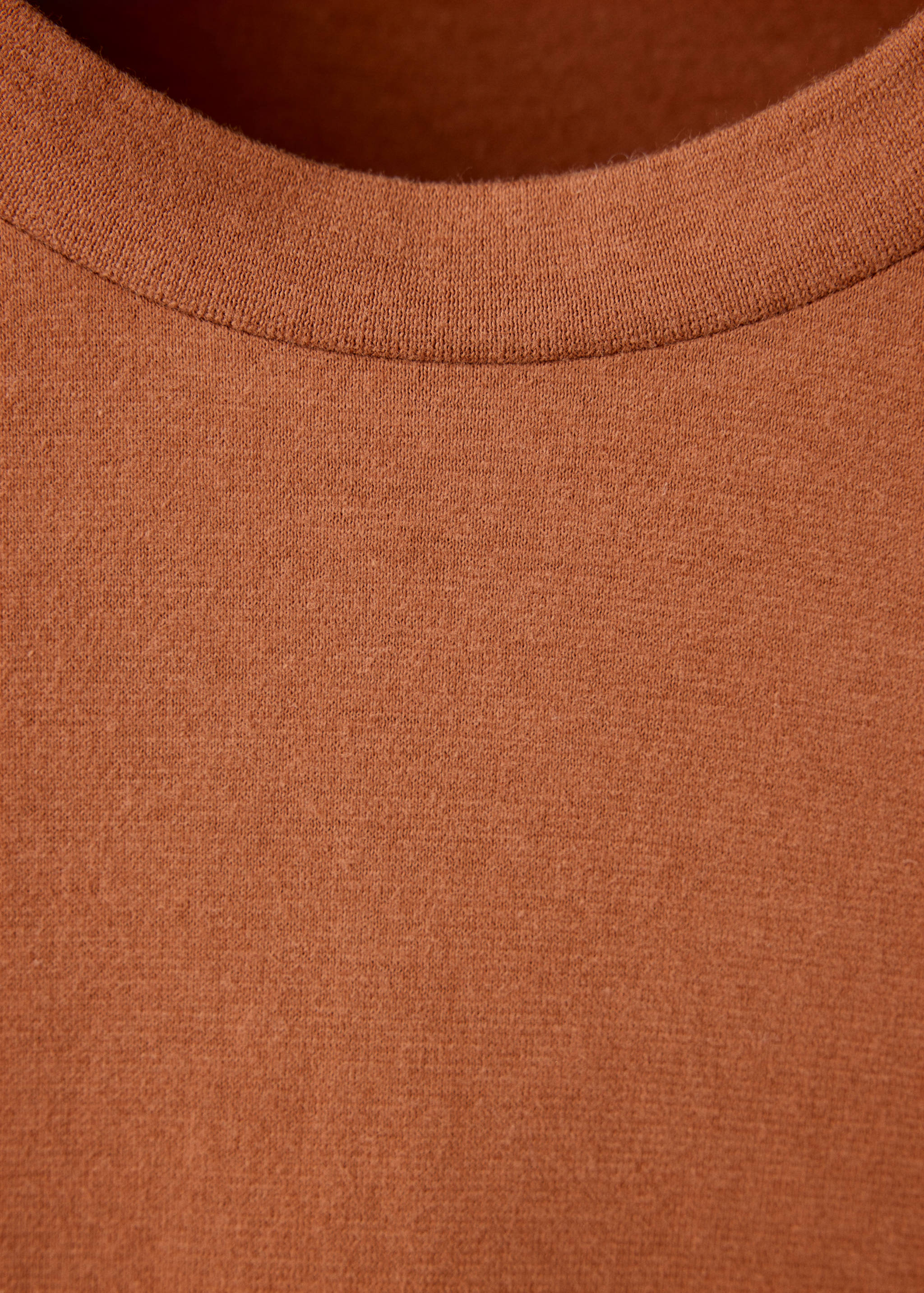 Rust brown t-shirt neckline detail.
