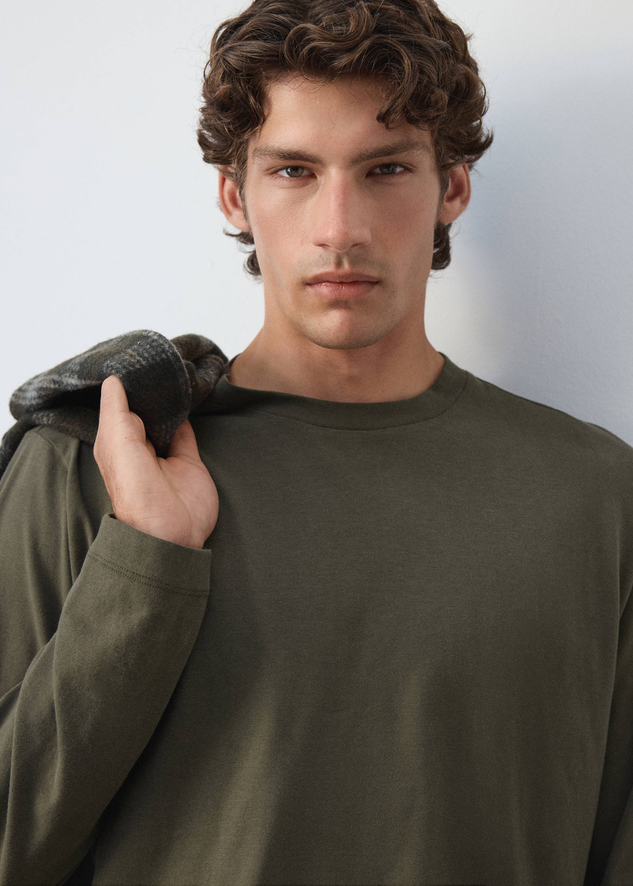Olive green long-sleeve crew neck t-shirt.