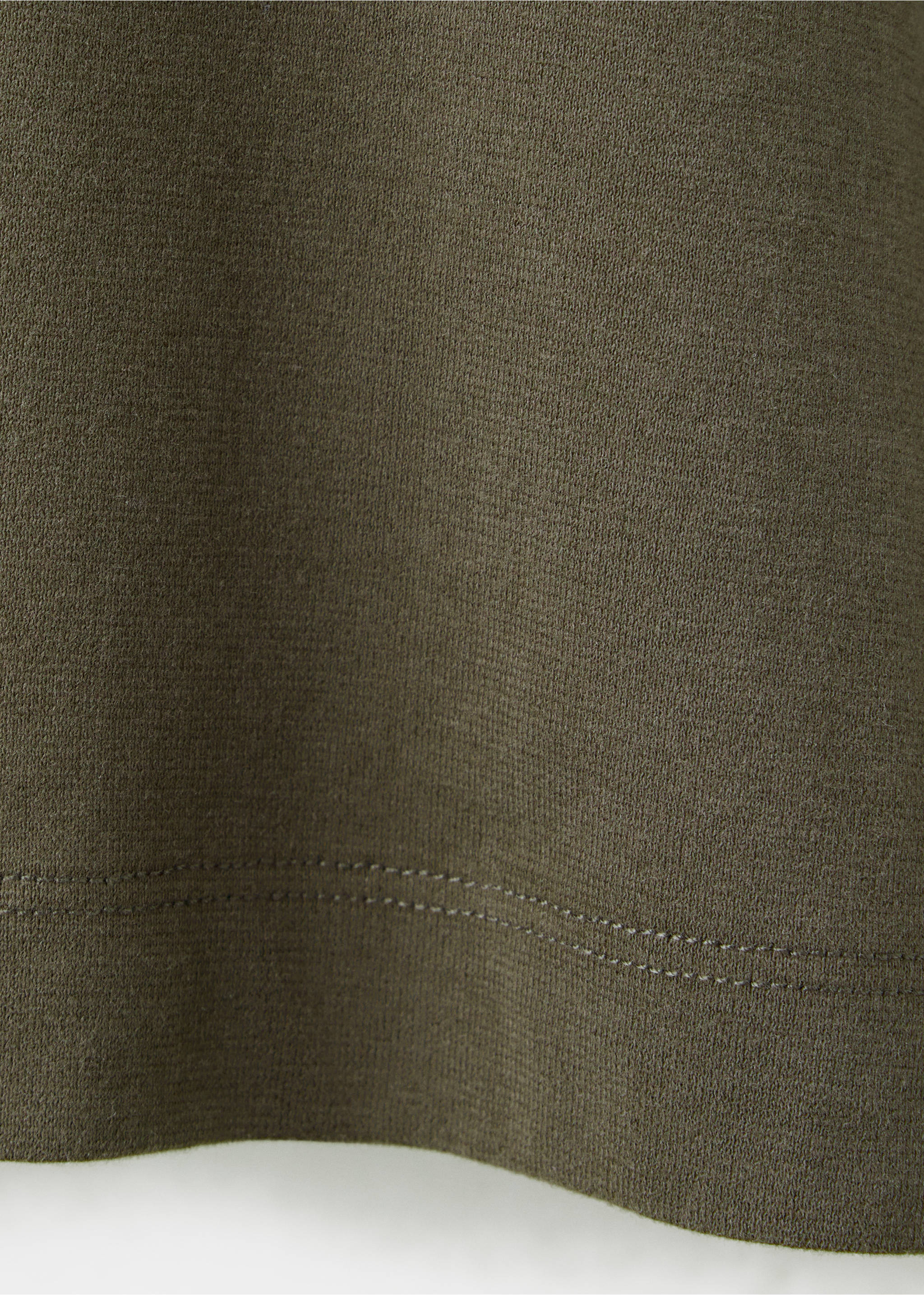 Close-up of olive green t-shirt fabric texture and hem., Olive Green. Ref: 37067912-00.
